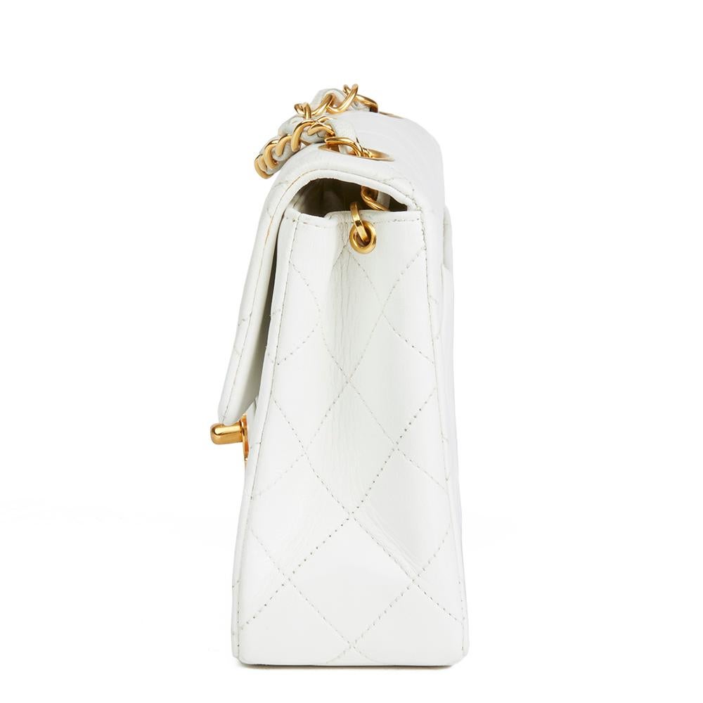 CHANEL
White Quilted Lambskin Vintage Mini Flap Bag

 Reference: HB1889
Serial Number: 2462620
Age (Circa): 1993
Accompanied By: Chanel Dust Bag, Authenticity Card
Authenticity Details: Authenticity Card, Serial Sticker (Made in France)
Gender: