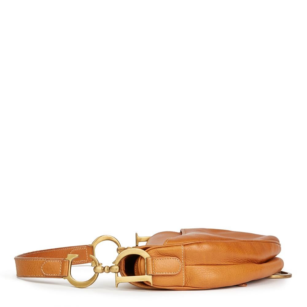 CHRISTIAN DIOR
Tan Calfskin Leather Saddle Bag

Reference: HB2098
Serial Number: RU0012
Age (Circa): 2002
Authenticity Details: Date Stamp (Made in Italy) 
Gender: Ladies
Type: Shoulder, Tote

Colour: Tan
Hardware: Gold
Material(s): Calfskin