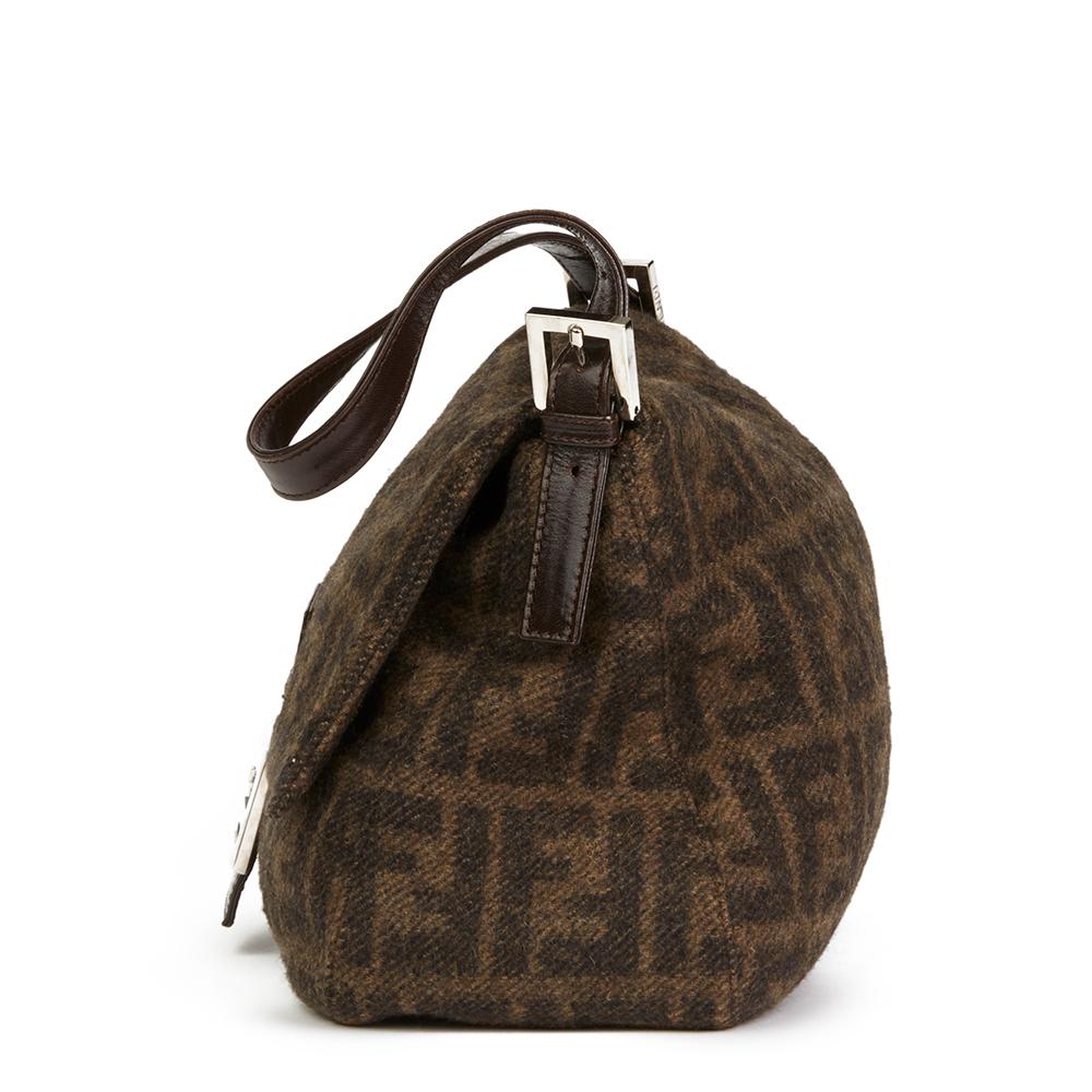 FENDI 
Brown Monogram Wool Mama Baguette 

 Reference: HB2096
Serial Number: 2321.26325.099
Age (Circa): 2000
Authenticity Details: Serial Stamp (Made in Italy) 
Gender: Ladies
Type: Shoulder, Tote

Colour: Brown
Hardware: Silver
Material(s): Wool,