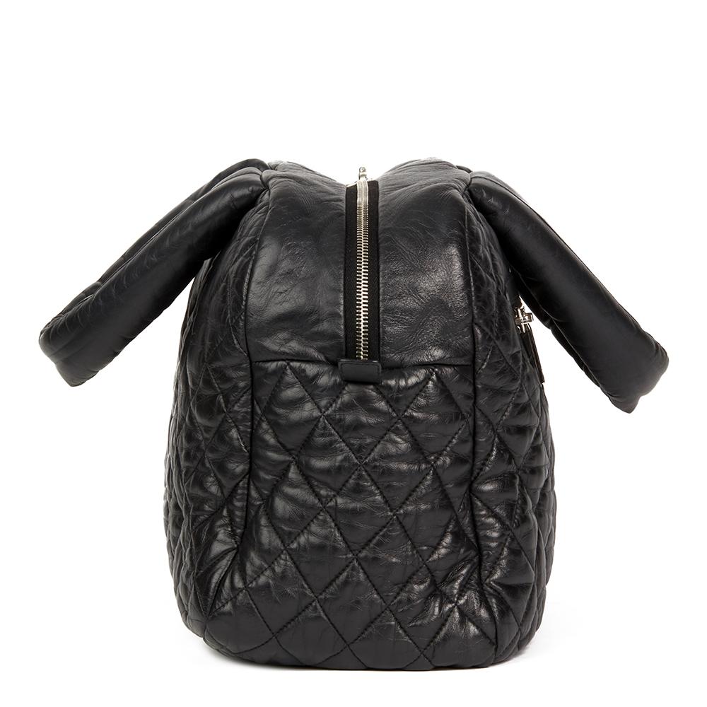 CHANEL
Black Quilted Lambskin Coco Cocoon Bowling Bag

 Reference: HB2132
Serial Number: 13199779
Age (Circa): 2009
Authenticity Details: Serial Sticker (Made in Italy)
Gender: Ladies
Type: Shoulder, Tote

Colour: Black
Hardware: Silver
Material(s):