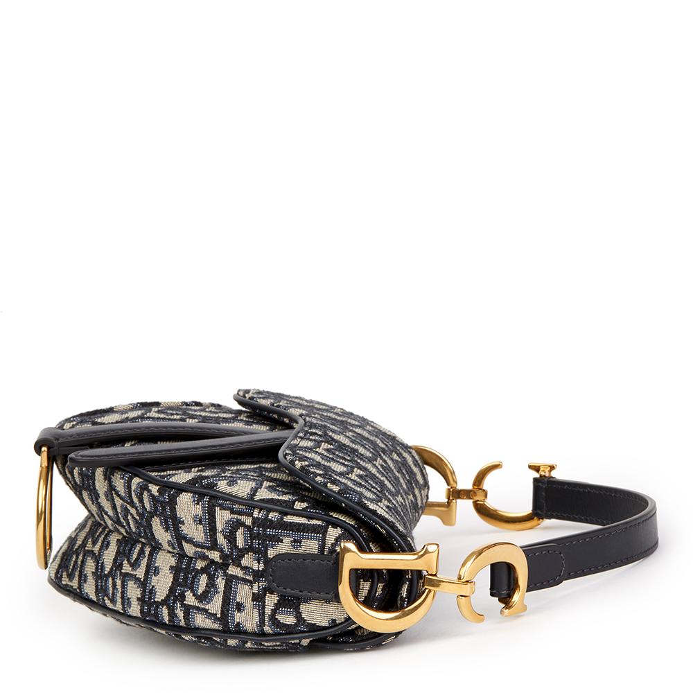 CHRISTIAN DIOR
Blue Oblique Monogram Canvas Mini Saddle Bag

 Reference: HB2037
Serial Number: 03-RU-0168
Age (Circa): 2018
Accompanied By: Dior Dust Bag, Box, Authenticity Card, Care Booklet, Protective Felt, Copy of Selfridges Receipt
Authenticity