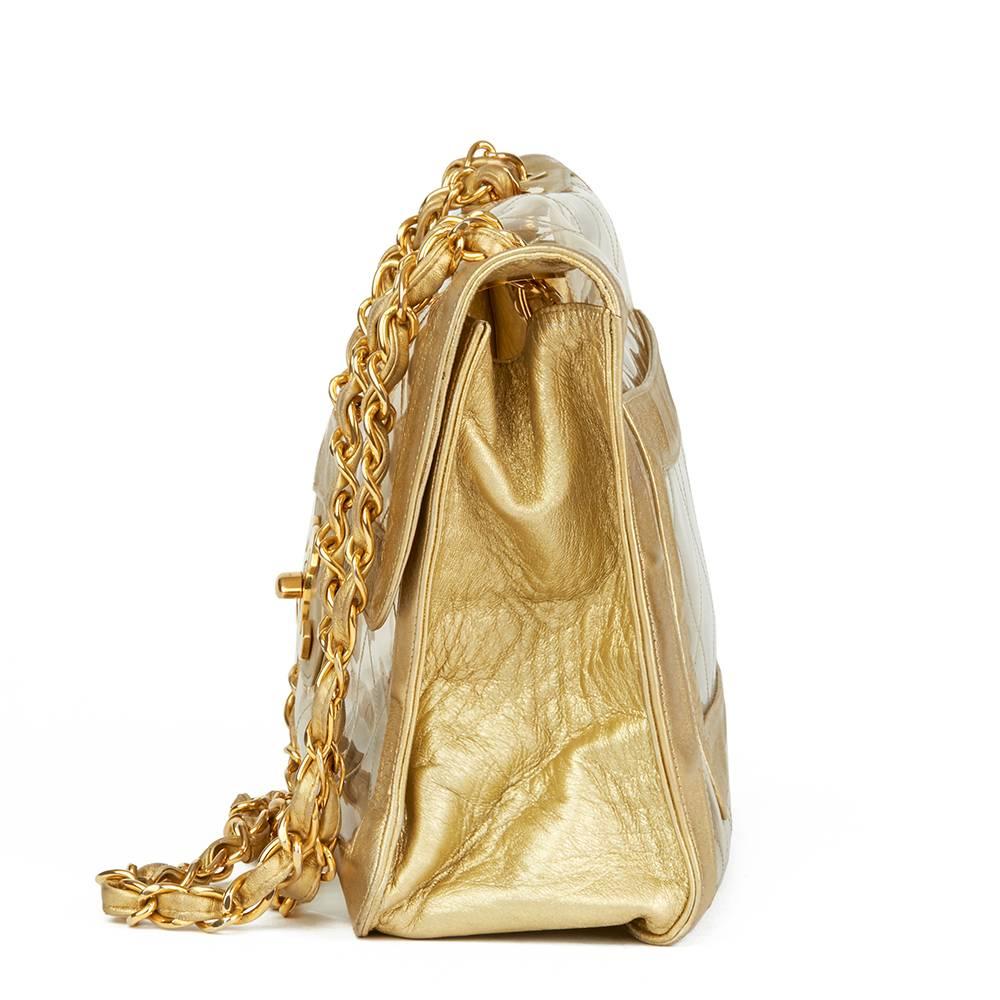 CHANEL
Gold Metallic Lambskin & Transparent PVC Vintage Naked Jumbo XL Flap Bag

 Reference: HB1826
Serial Number: Serial Sticker no longer readable
Age (Circa): 1996
Authenticity Details: Serial Sticker (Made in France)
Gender: Ladies
Type: