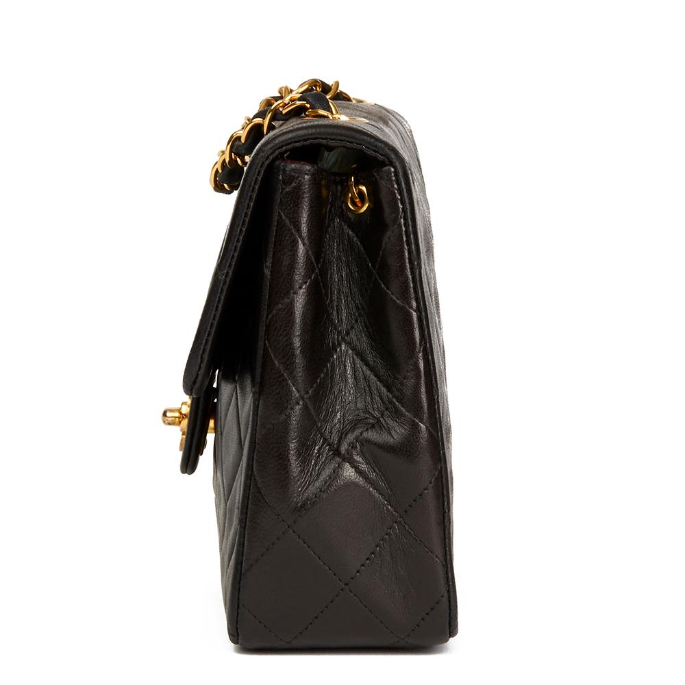 CHANEL
Black Quilted Lambskin Vintage Mini Flap Bag

 Reference: HB2226
Serial Number: 2528427
Age (Circa): 1992
Authenticity Details: Serial Sticker (Made in France)
Gender: Ladies
Type: Shoulder, Crossbody

Colour: Black
Hardware: Gold (24k