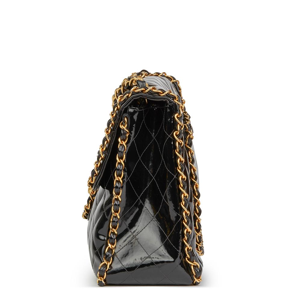 CHANEL
Black Quilted Vinyl Chain Around Vintage Maxi Jumbo XL Flap Bag

 Reference: HB2270
Serial Number: 3284427
Age (Circa): 1994
Authenticity Details: Serial Sticker, (Made in France)
Gender: Ladies
Type: Shoulder

Colour: Black
Hardware: Gold