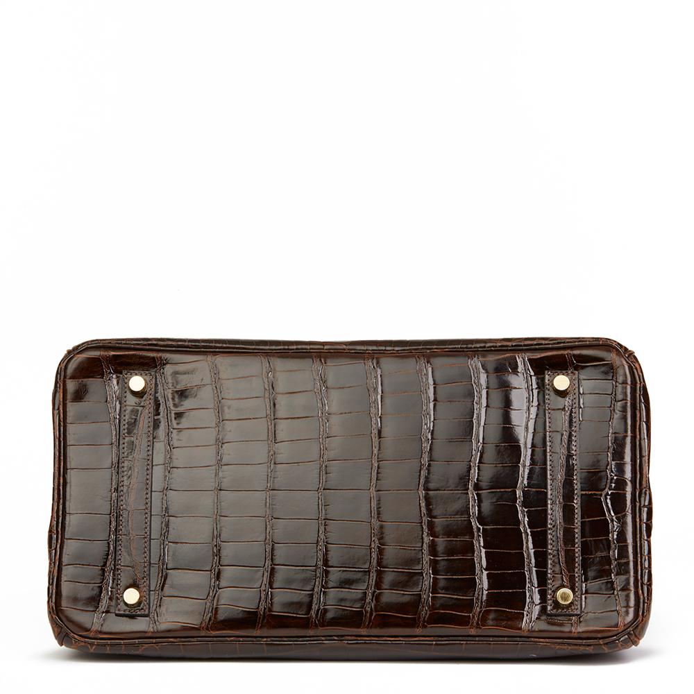 HERMÈS
Chocolate Brown Shiny Porosus Crocodile Leather Birkin 35cm

Reference: HB2256
Serial Number: [Q]
Age (Circa): 2013
Accompanied By: Hermès Dust Bag, Box, Lock, Keys, Clochette, Rain Cover, Care Booklet
Authenticity Details: Date Stamp (Made