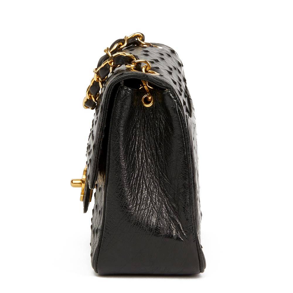CHANEL
Black Ostrich Leather Vintage Mini Flap Bag

 Reference: HB2289
Serial Number: 0579298
Age (Circa): 1987
Accompanied By: Chanel Dust Bag, Authenticity Card
Authenticity Details: Serial Sticker, Authentity Card (Made in France)
Gender: