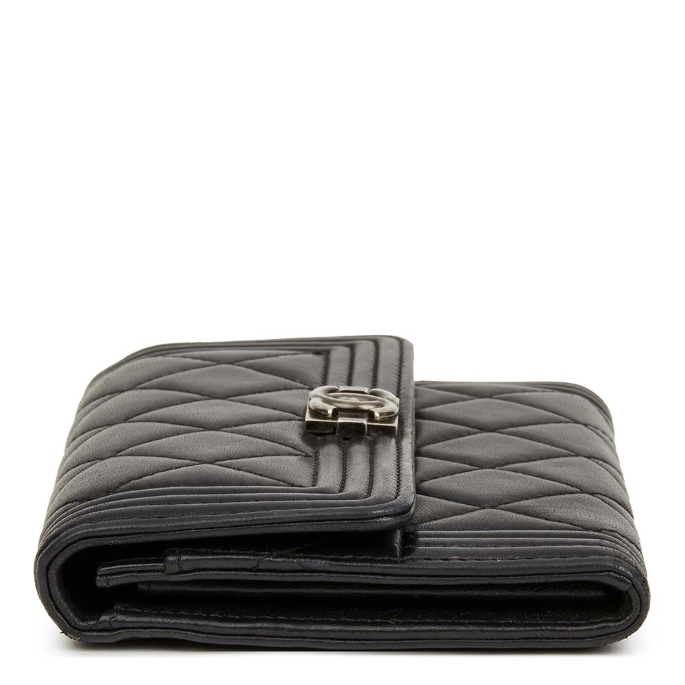  CHANEL
Black Quilted Lambskin Boy Flap Wallet

Reference: HB2324
Serial Number: 20289557
Age (Circa): 2014
Accompanied By: Chanel Dust Bag, Box, Care Booklet 
Authenticity Details: Serial Sticker (Made in Italy)
Gender: Ladies
Type: