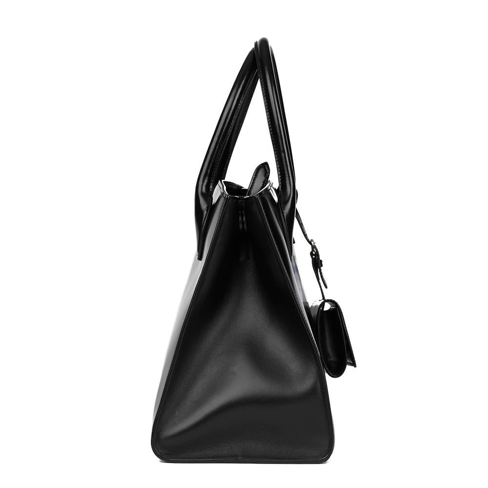 PRADA
Black Patent Leather Monochrome Tote

Reference: HB2337
Age (Circa): 2017
Accompanied By: Prada Dust Bag, Authenticity Card, Detachable Pouch, Shoulder Strap
Authenticity Details: Serial Tag is no longer present, Authenticity Card (Made in