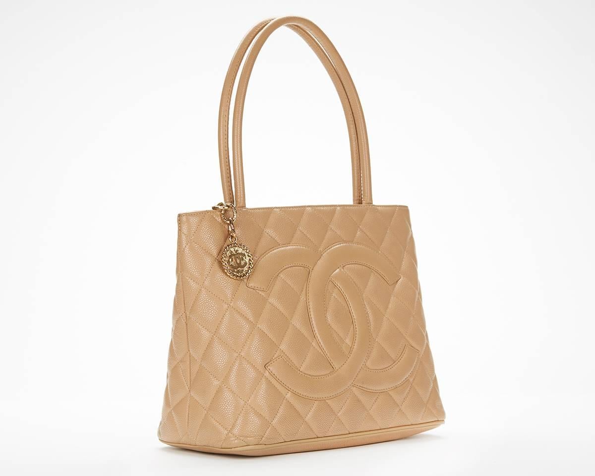 This Chanel Iconic Medallion Tote Bag is in good condition accompanied by Chanel dust bag. Circa 1990's. Primarily made from Caviar Leather complimented by Gold hardware. Our  reference is HB037 should you need to quote this.

This Chanel handbag