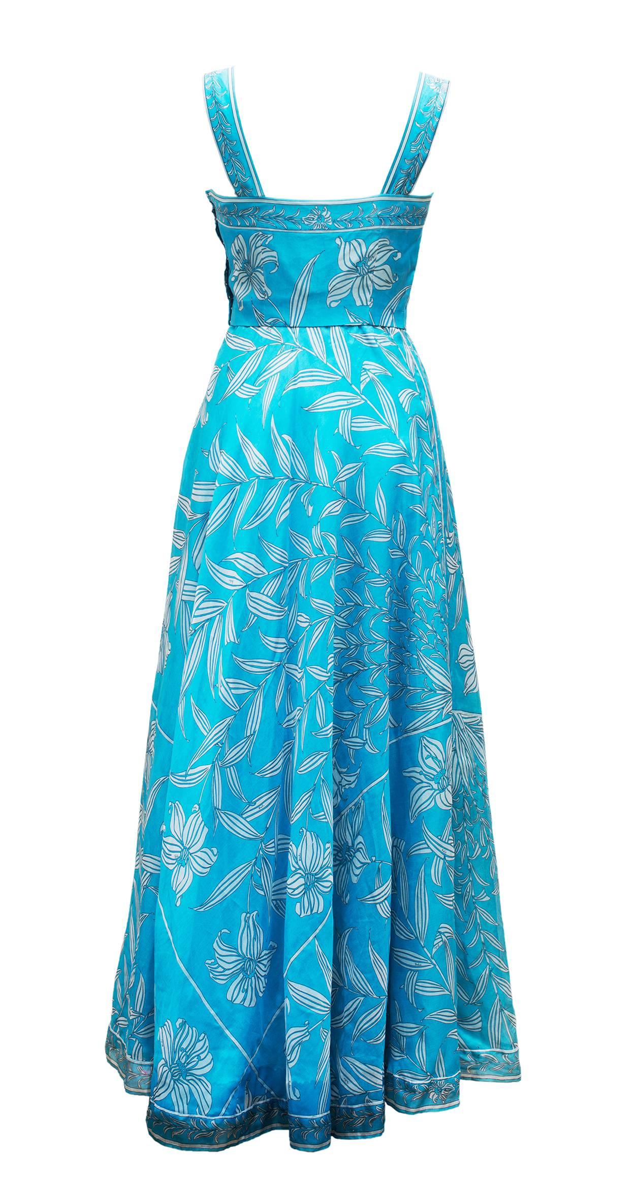 1960's Emilio Pucci Florence Italy Divine Long Organza Dress With Mini Cape. It's a very pretty blue long dress in organza printed of beautiful white flowers and plants. The dress have a "bustier " with two large straps and continue with a