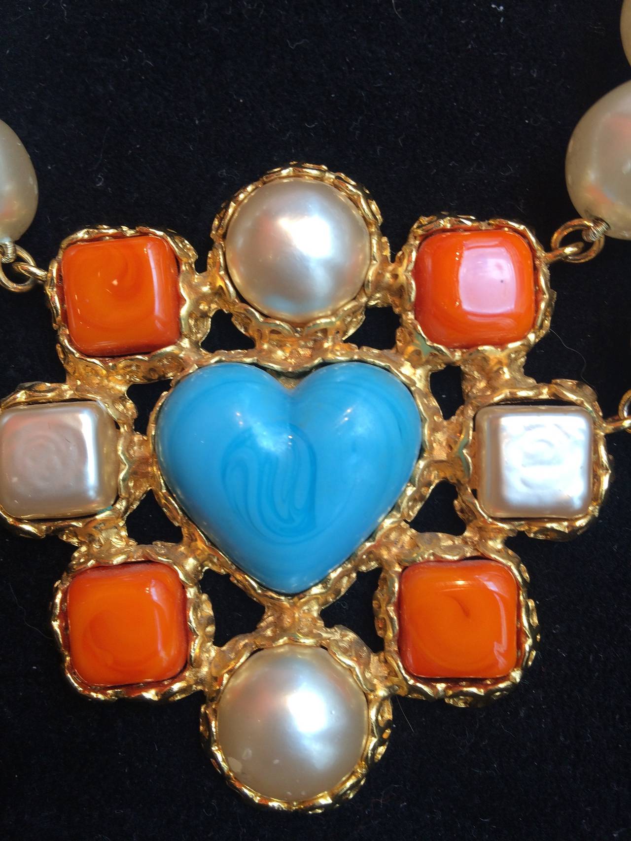 Amazing  2 strand necklace with a heart in turquoise resin in the middle and 4 square orange resin and fake pearls around  .