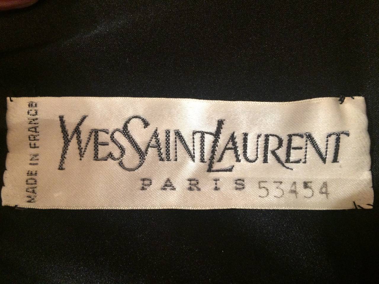 F/W 1982-1983 Yves Saint-Laurent Haute Couture  Evening Dress
A two-pece dress featuring a black silk velvet top and a long cream-colored crepe skirt. The top has a plunging V-neckline in both the front and the back and you have a bow on the front 