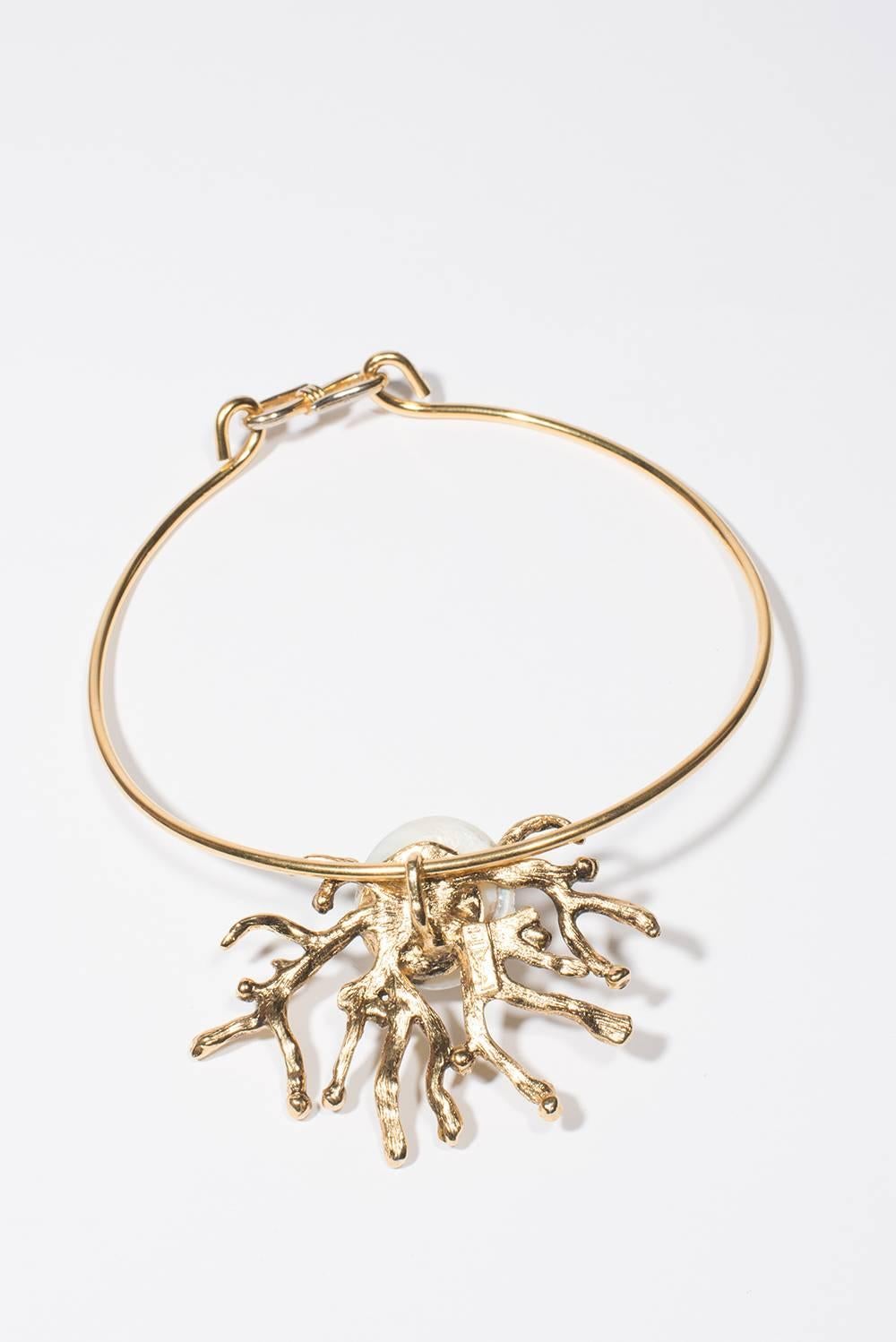 1990 Yves Saint Laurent Iconic Necklace
This magnificent necklace golden brass have in the center the iconic 
coral branch with the shell ( resin) designed by Robert Goossens for 

Yves Saint Laurent 