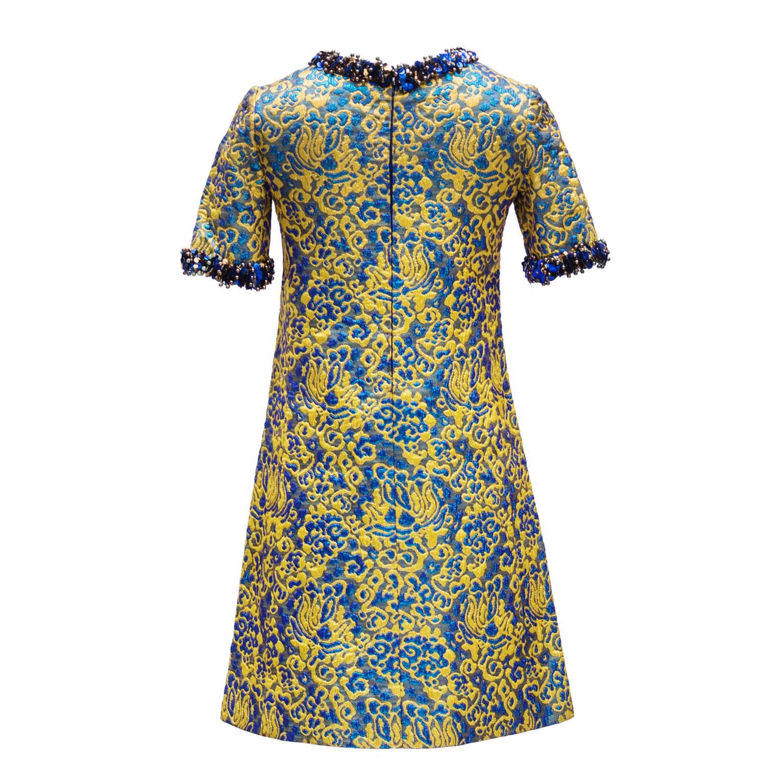 1966/67 Yves Saint Laurent Rive Gauche Divine Cocktail Dress

This is a divine short trapeze cocktail dress ; broché gold and blu .

Short sleeves and neck embroidered with gold and blue pearls and sequins 

few sequins missing but invisible when