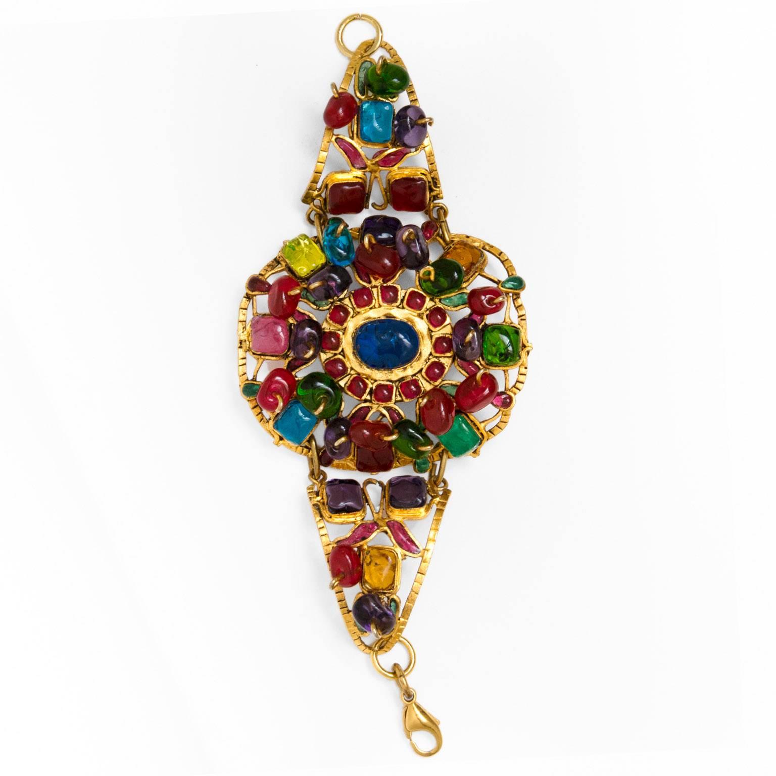 2003 Chanel Divine Multicolor Bracelet :                                                      Extraordinary bracelet gold metal composed of a sublime oval medallion decorated with stones in glass : green purple red yellow rose .
This bracelet