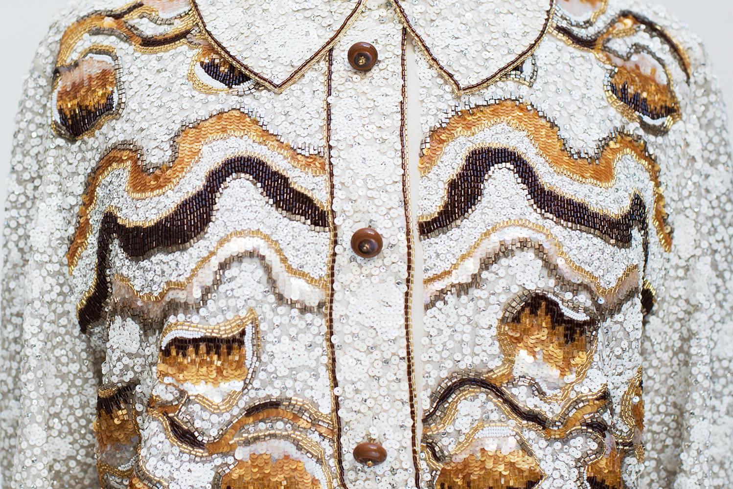 Chirstian Dior Paris, Spring/Summer Collection 1986 Haute Couture, Sequined, Top. 
Gorgeous top  white and silvered sequins. On the face there is beautiful motifs  with brown, golden and ocher perles. The collar and sleeves are embroidered of two