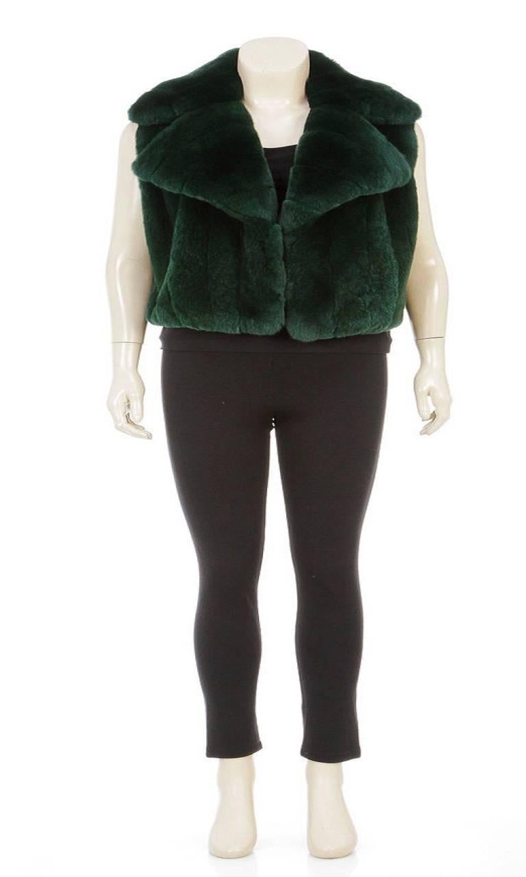 This luxuriously elegant emerald green fur vest from Roberto Cavalli features authentic fur construction in a chunky knit along with a 100% silk lining, creating an incredible combination of warmth and comfort. It has large, wide notch lapels that