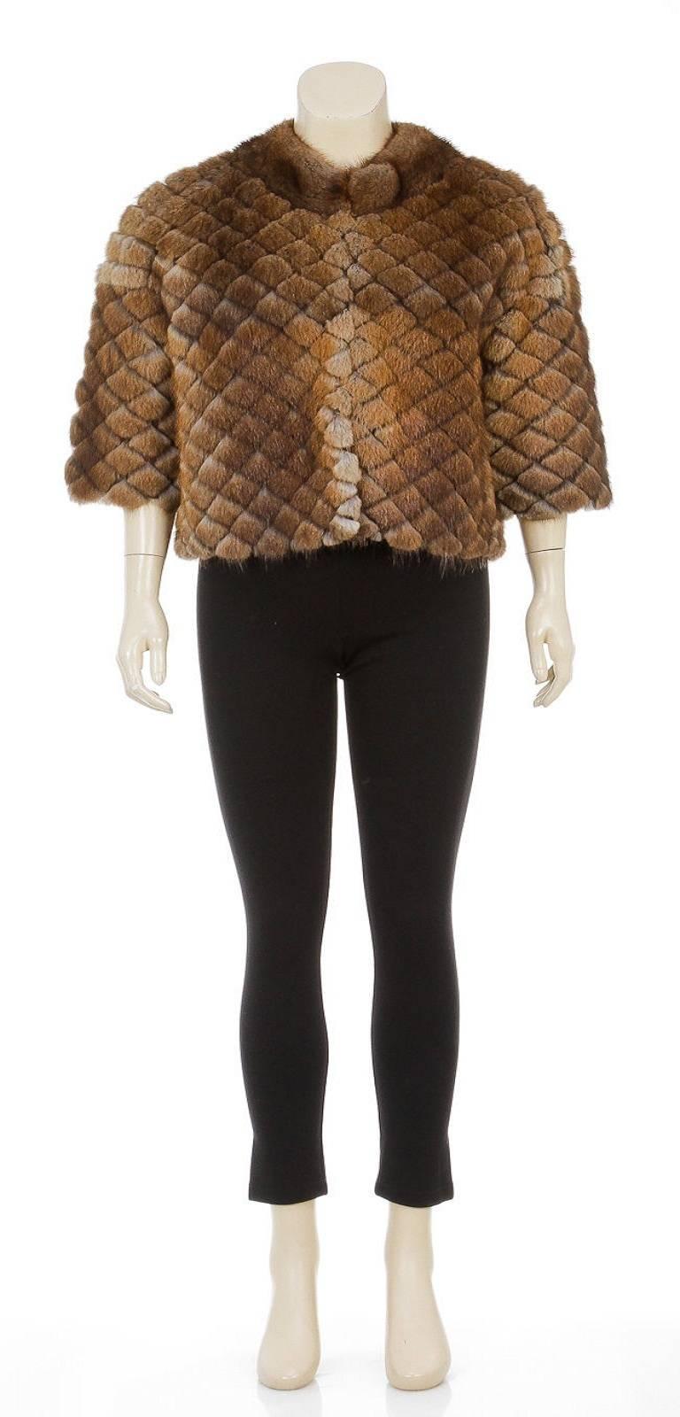 lip in luxury with this J. Mendel fur jacket! This gorgeous is crafted from ultra glamorous muskrat fur and can definitely become your new go-to piece this upcoming fall and winter. Hook and eye closures are available to secure this jacket closed.