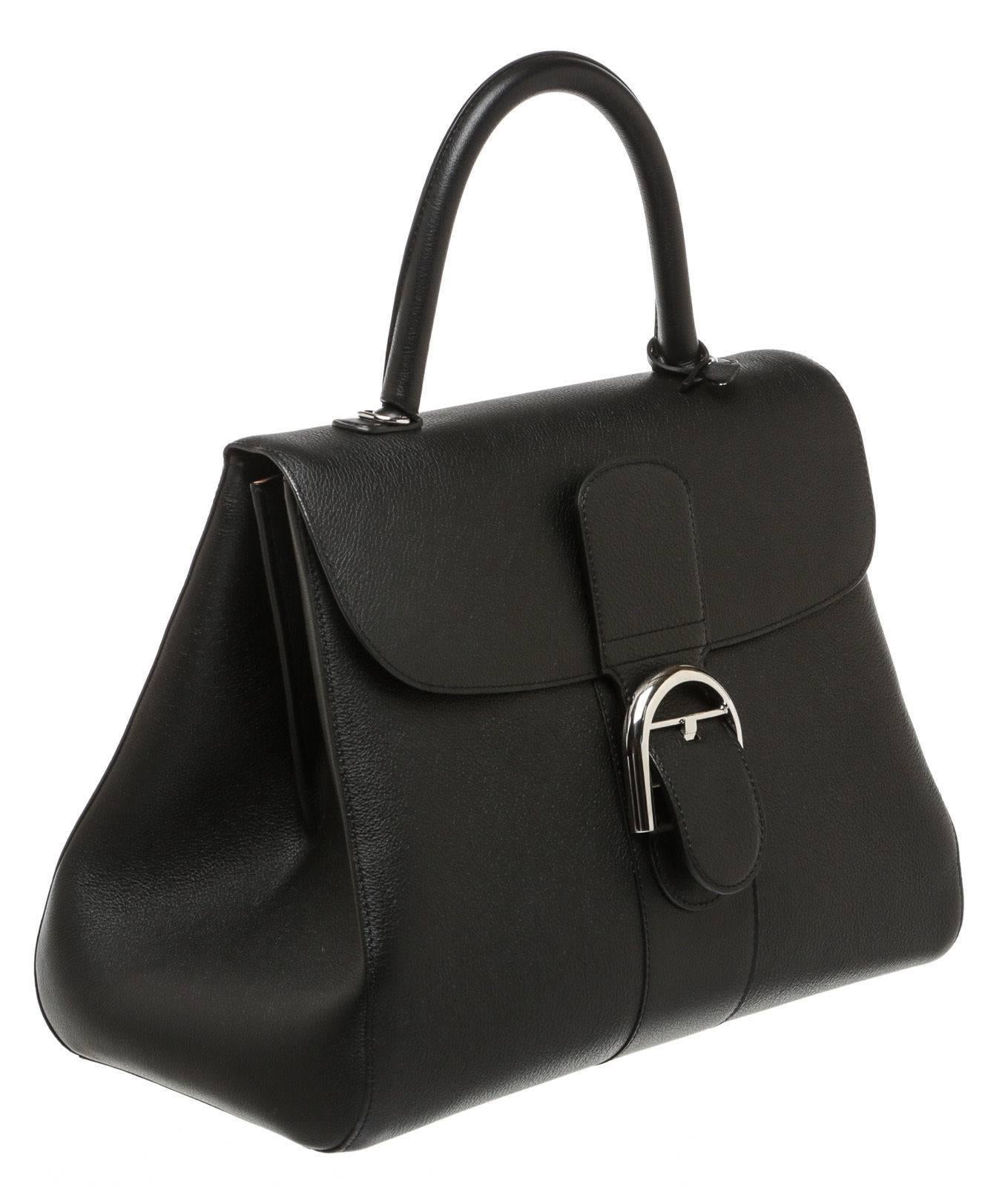 Designer: Other
Type: 
Handbag
Condition: 
Exterior: Pre-owned in very good condition - minor wear
Interior: Pre-owned in very good condition - minor wear
Color: 
Black
Material: 
Leather
Dimensions: 
13.25