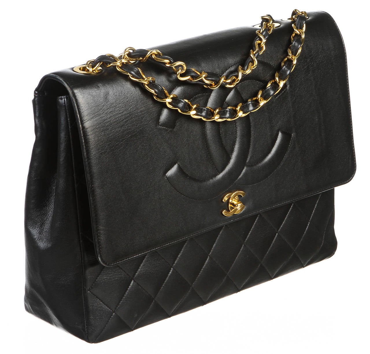 Step out in style with this absolutely amazing Chanel vintage handbag. This handbag has been crafted from black lambskin and features all of your favorite details that you would find in a classic handbag. The larger prominent turn lock is one of our
