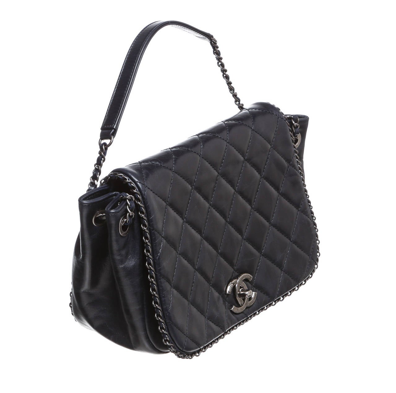 Add this gorgeous handbag to your Chanel collection today! This stunning piece of art is constructed with a dark navy blue lambskin with a quilted flap featuring the Mademoiselle twist lock for a secure wear. A chic chain and leather trim can also