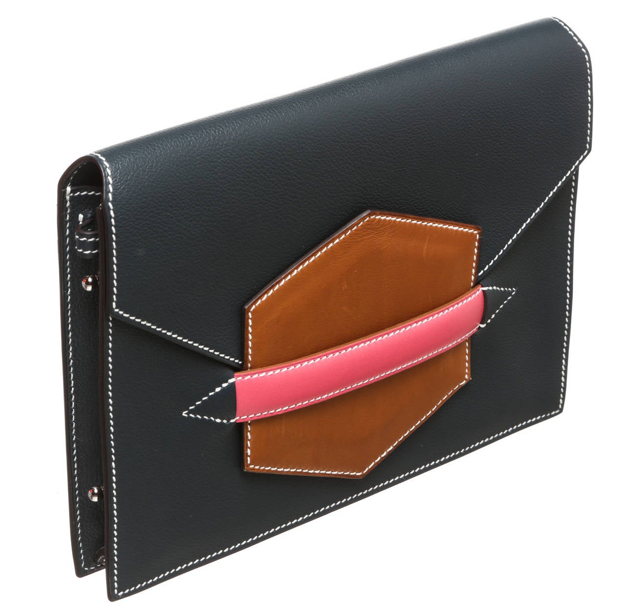 Featured here is this gorgeous and highly coveted Hermes clutch handbag that will become your new favorite! Find out why we are going crazy over this tricolored handbag which is crafted from a dark blue swift leather with a large complementary brown