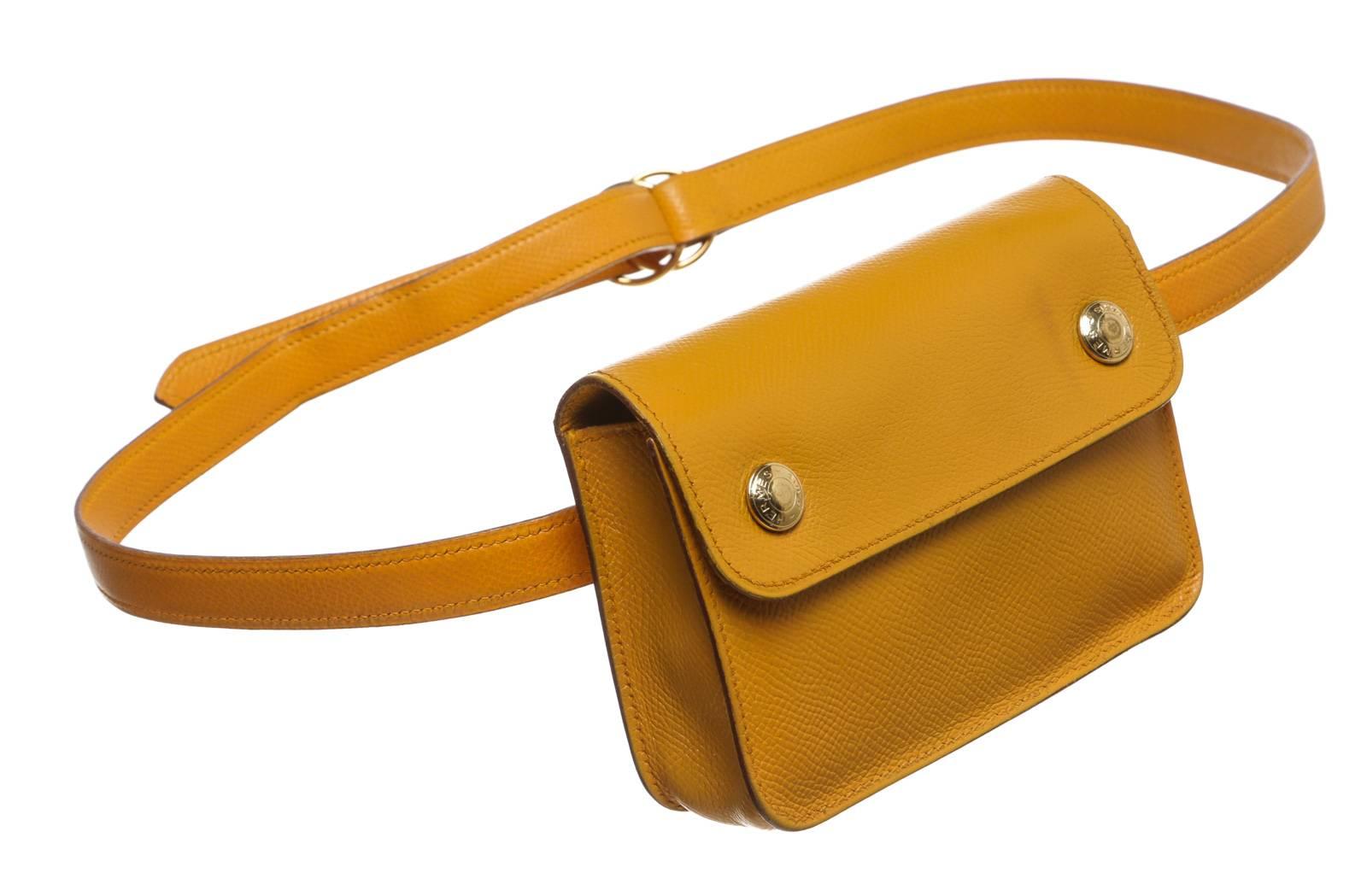 Sport the latest statement pieces like this stunning Hermes epsom leather bag! This waist bag can be secured by looping the straps through two rings. Two snap buttons can be opened to to reveal just enough space for the essentials, like cards and a