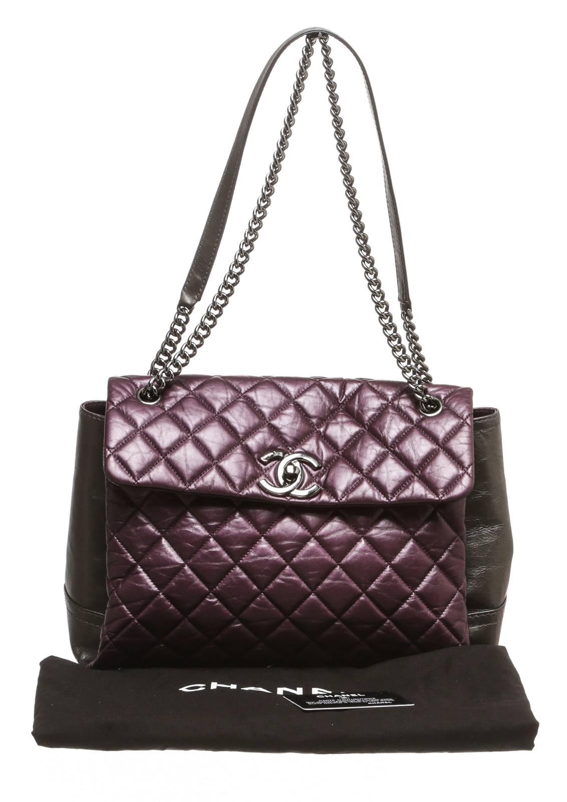 Show off your signature style with this gorgeous Chanel handbag. This fabulous handbag is called the Lady Pearly and thanks to the iridescent leather, you'll know why. This bi-color bag is featured in purple and gray with silver tone hardware.