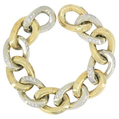 Bracelet vintage Pomellato en or jaune et blanc 18 carats, bicolore, orné de diamants et composé de maillons de type « curb »
