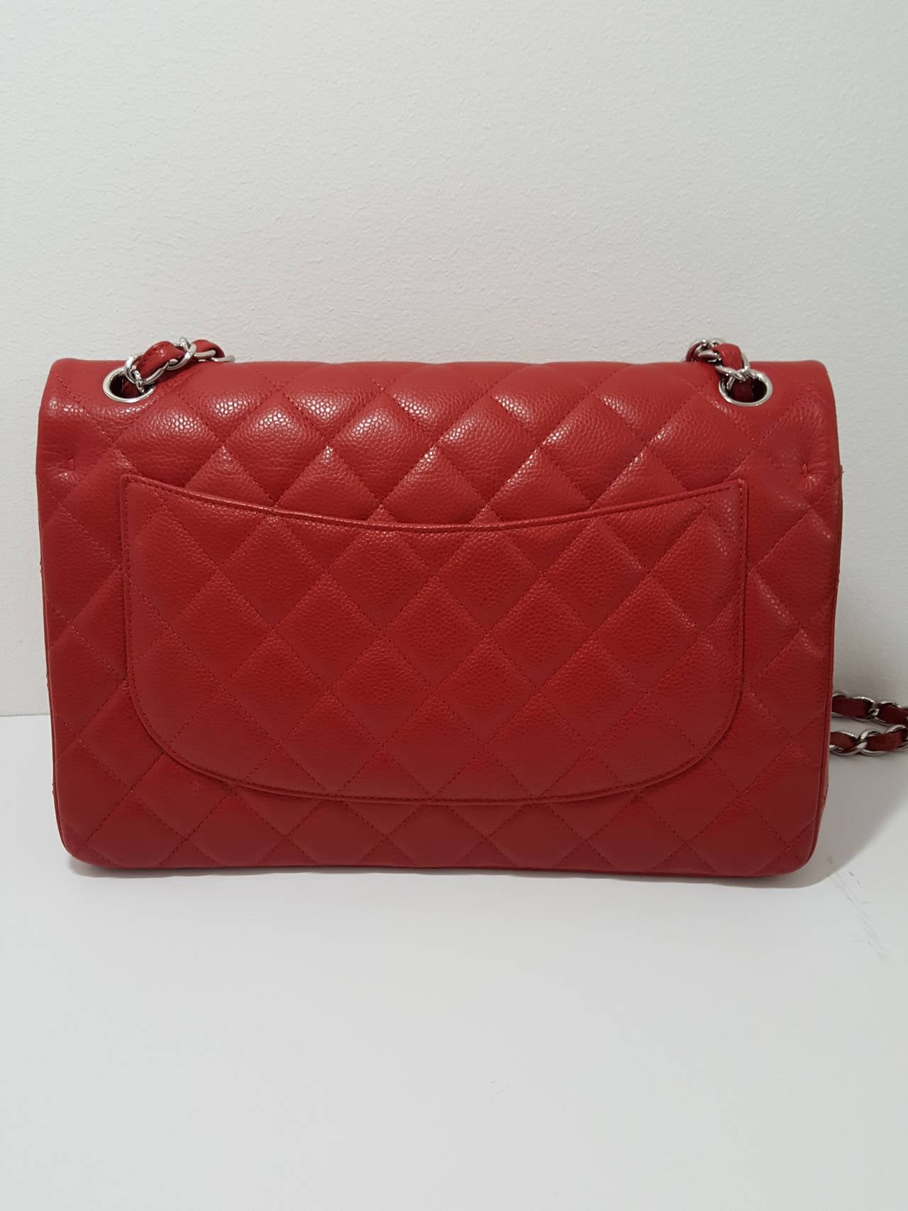 Here is the one you have been waiting for.  A New, never worn Chanel red caviar Jumbo double flap with silver hardware. It  can be carried on your shoulder or long enough to wear cross body.  This bag comes complete with card, booklet, Polishing