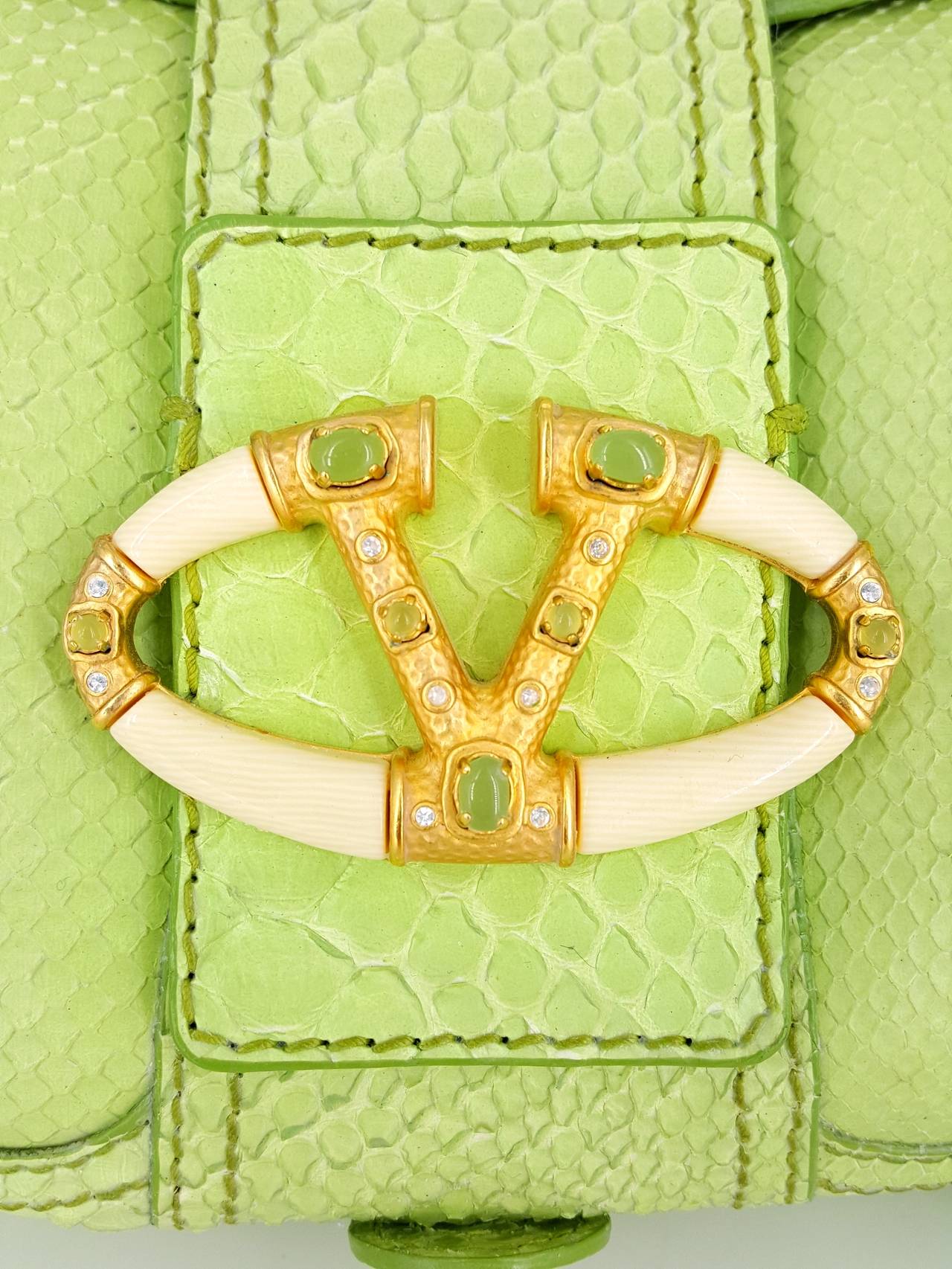 Offered for sale is the fabulous lime green Valentino Python Satchel with large faux ivory clasp embellished with jade.  This handbag has the original tags and was never carried.  The color is outstanding.  There is one large zippered  compartment