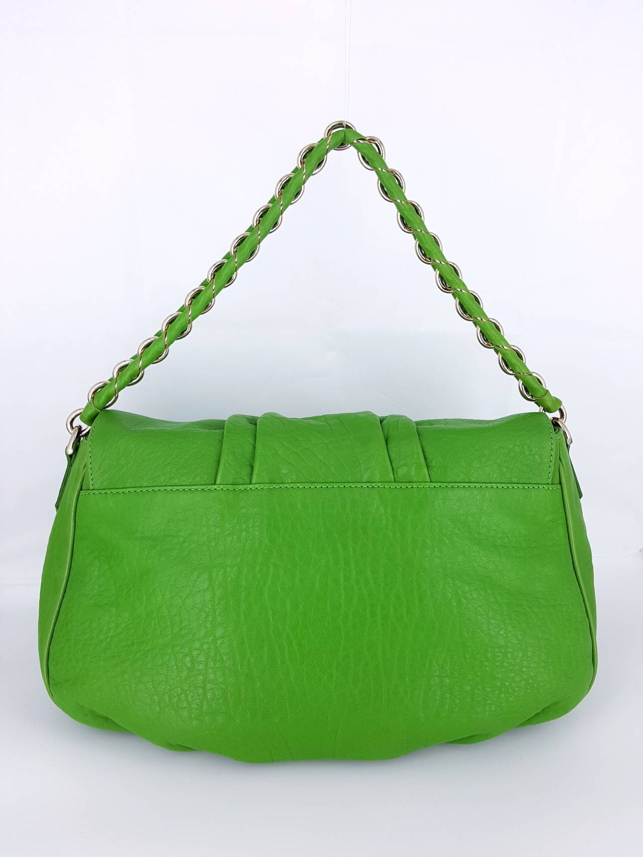 What a great color Fendi in Kelly Green Leather and silver hardware.  The large silver FF magnetic closure and metal on the shoulder strap really set this off nicely.  The soft textured leather makes it comfortable to carry.  There is a large