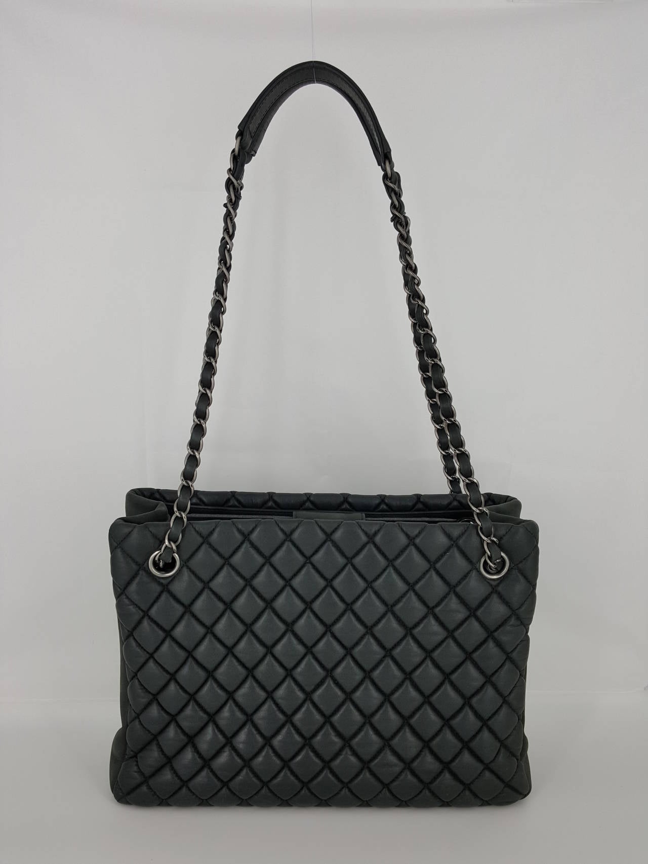 Offered for sale is this CHANEL Petite Shopper in Charcoal which was a Limited Edition for Saks.  This handbag has darkened silver hardware and has a puffy diamond pattern.  Just a little twist from the normal Petite Shopper but makes it unique.  It
