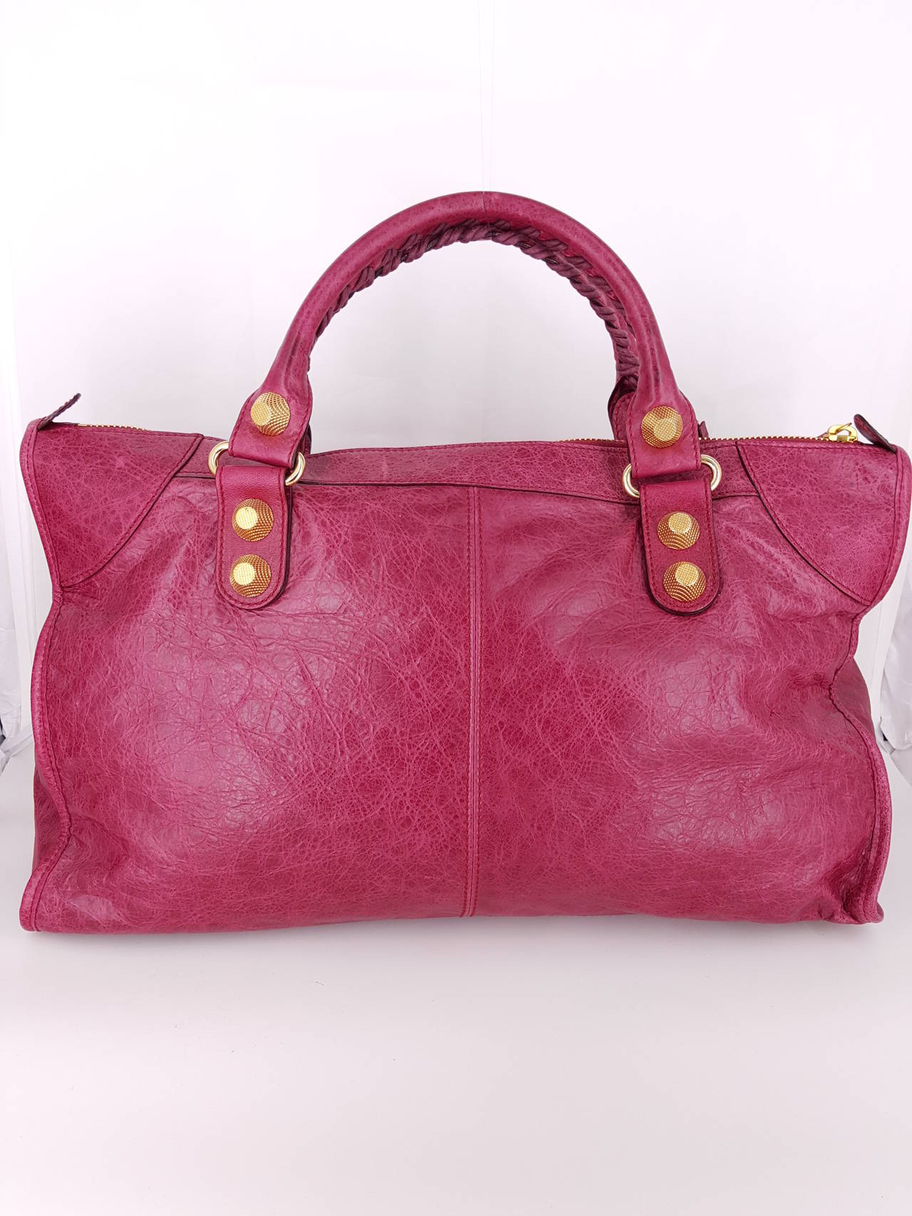 Offered for sale is a large Balenciaga Work City bag in stunning Magenta distressed leather in perfect condition.  This is a great handbag or travel bag and for it's size, is very light weight.  The magenta leather with the gold hardware makes a