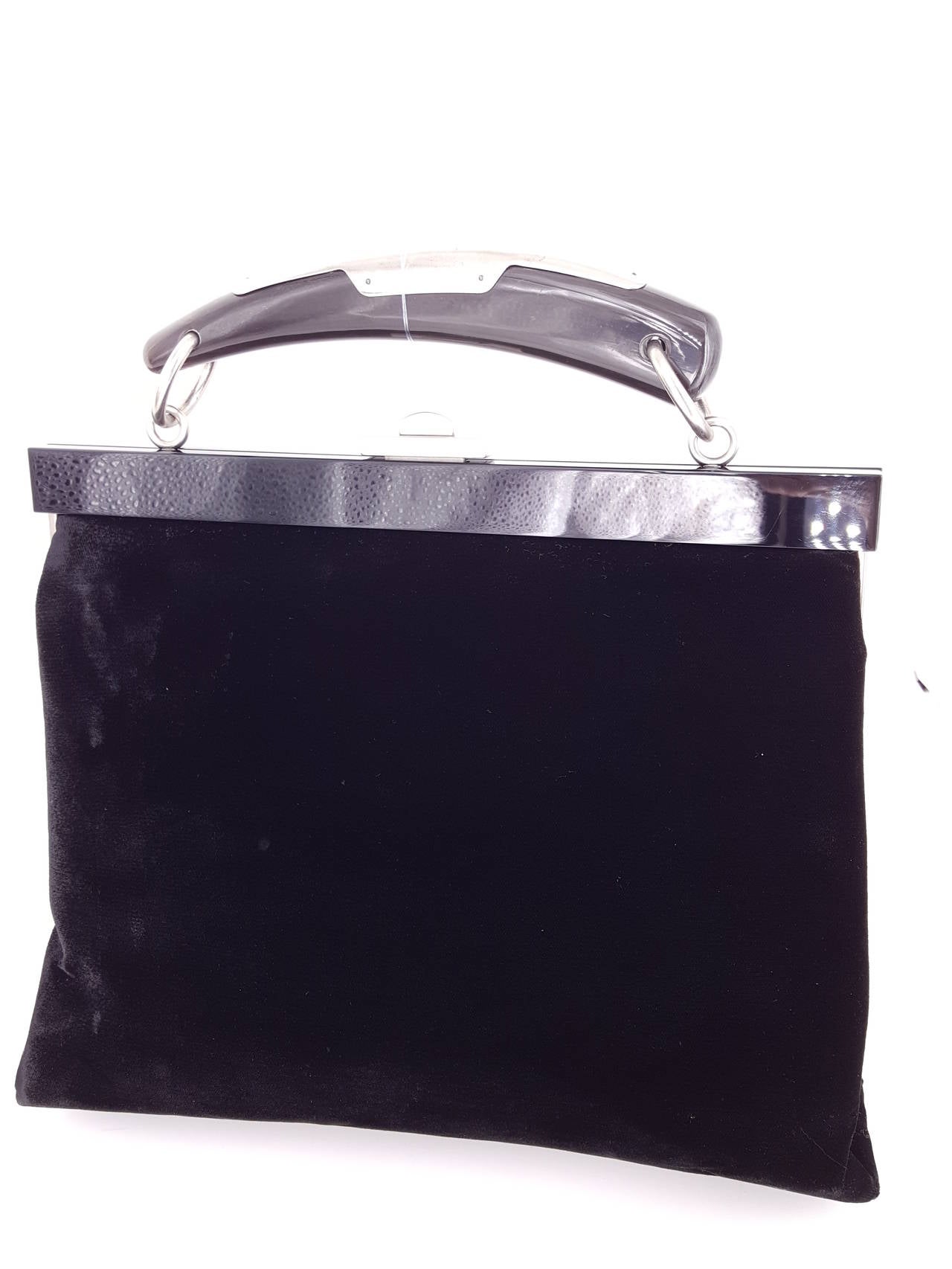 Offered for sale is this limited edition YSL velvet Mombasa Handbag in black with with Black Lucite and silver horn handle.  This is a really elegant handbag from the Mombasa collection that Tom Ford did for the House of Saint Laurent.
The interior