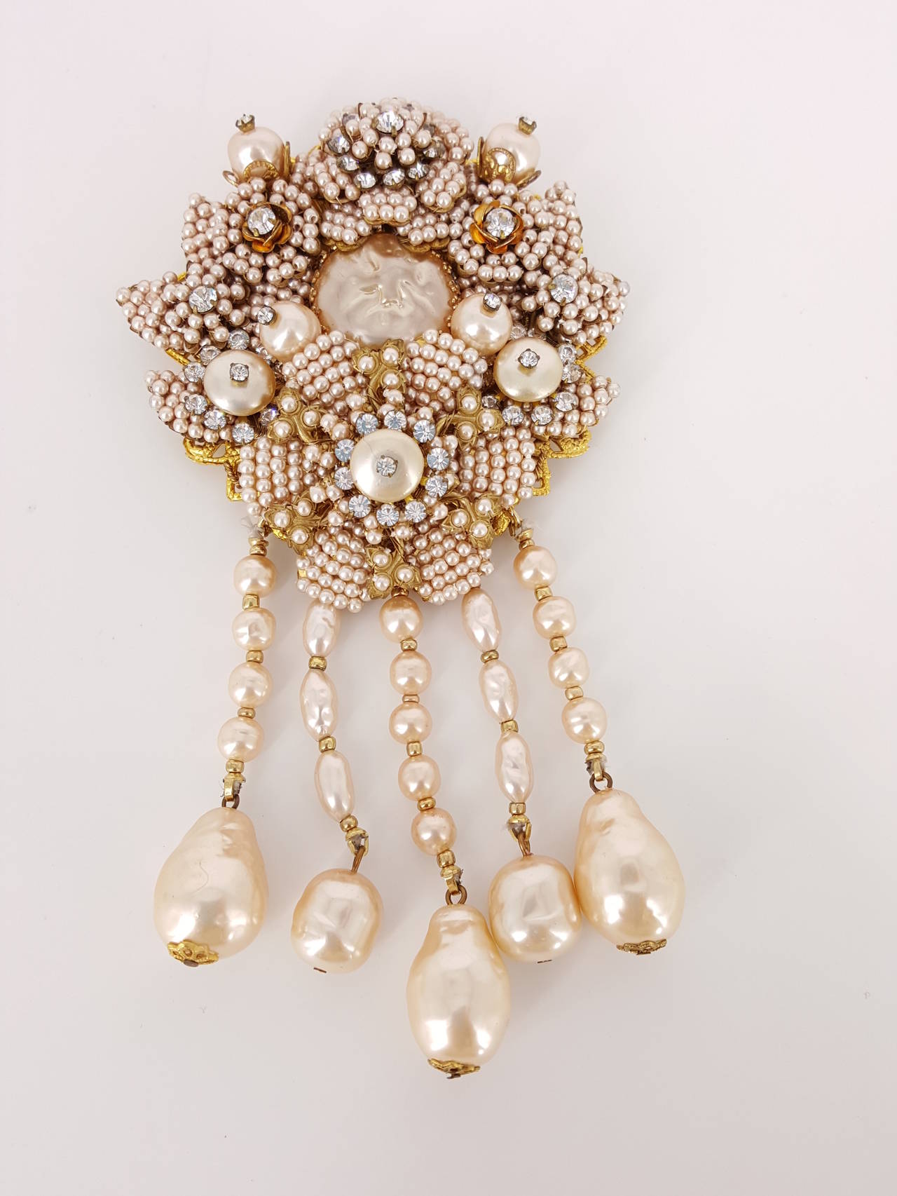 Offered for sale is this gorgeous large brooch and earrings  by Stanley Hagler of N.Y.  The soft pinkish Baroque pearls and seed pearls are accented with rhinestones set in flowers.  There are for strands of baroque pearls that hange from the bottom
