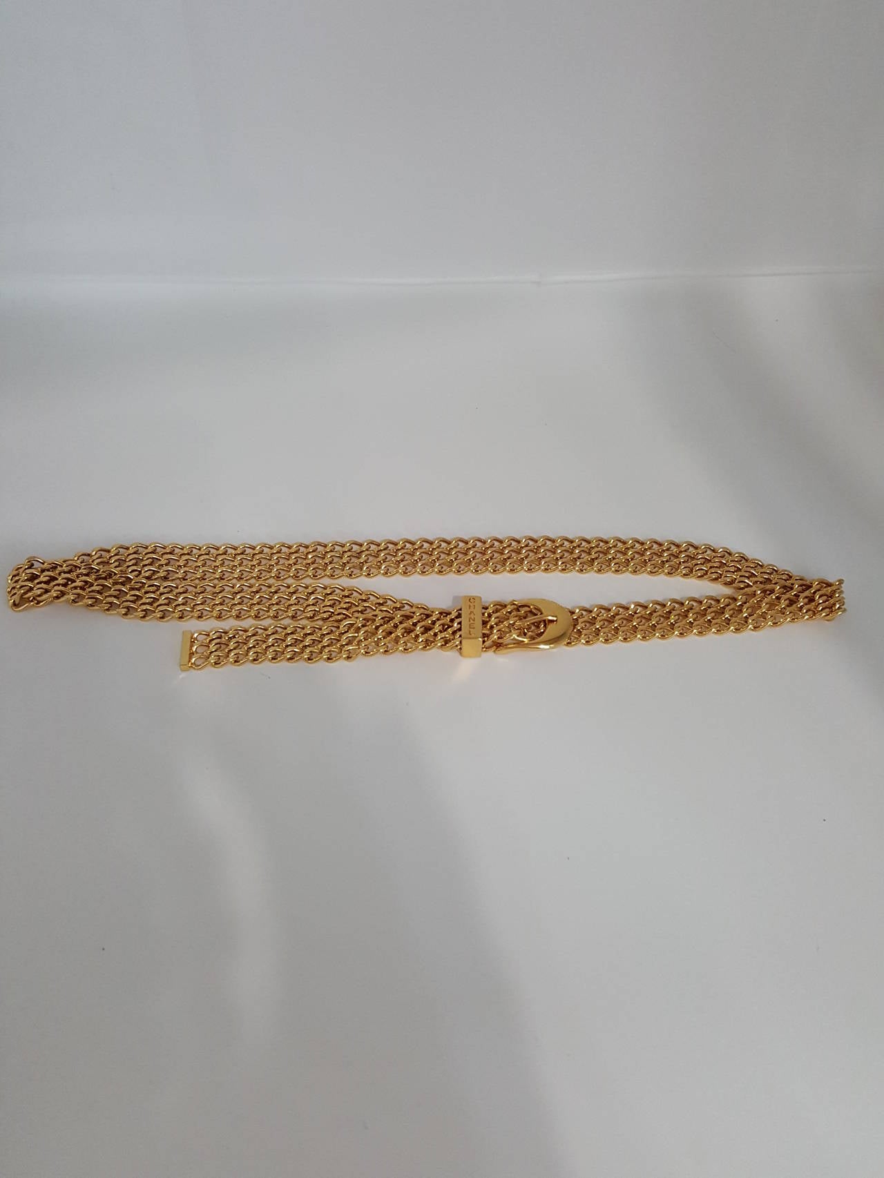 Offered for sale is this rare Chanel Woven Chain belt/necklace in bright gold finish.
This timeless piece is from 1997 and in like new condition.  It is very adjustable as you use the mesh to close the clasp.  It is 3/4 wide and it's full length is