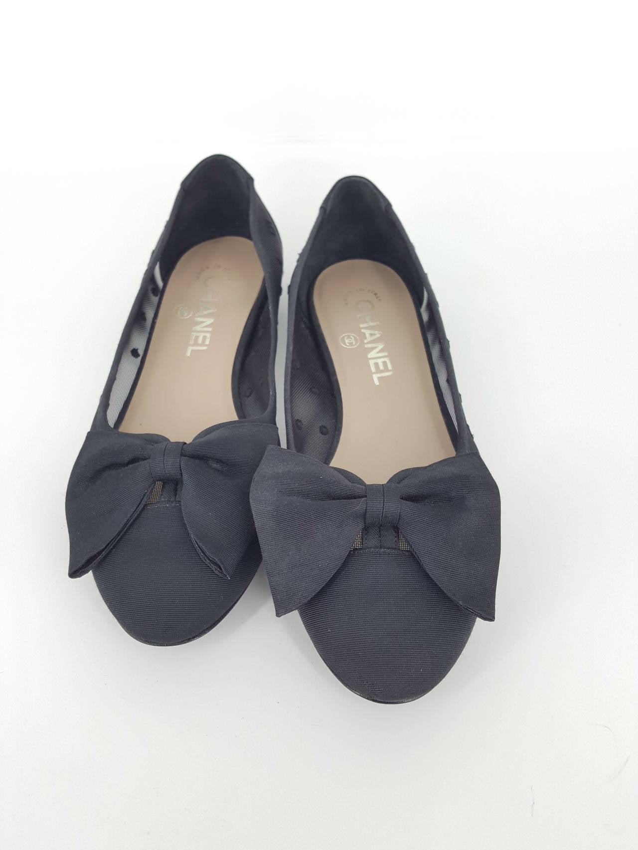 Offered for sale is this darling pair of Chanel ballet flats in black fabric and mesh with the number 