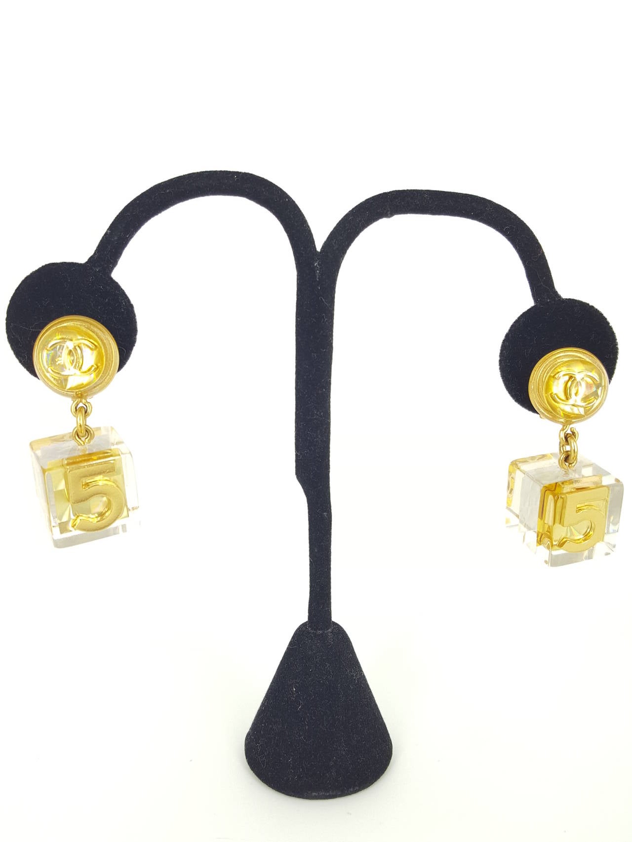 Offered for sale is a fabulous  pair of Chanel Vintage earrings in Lucite and gold with a large 