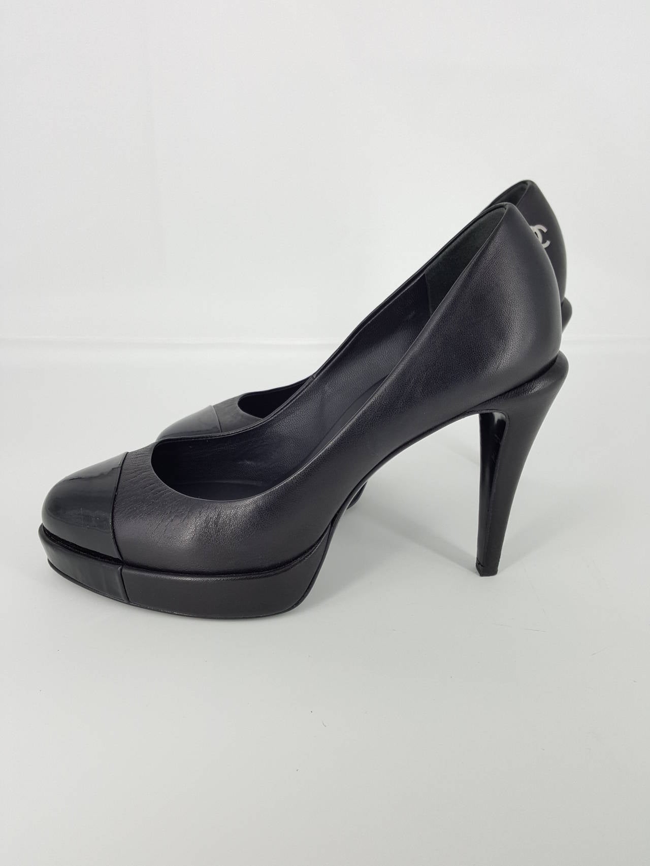 Offered for sale is a beautiful pair of Chanel platform high heels.  These are Black calf skin leather with a patent leather toe cap.  There is a silver 