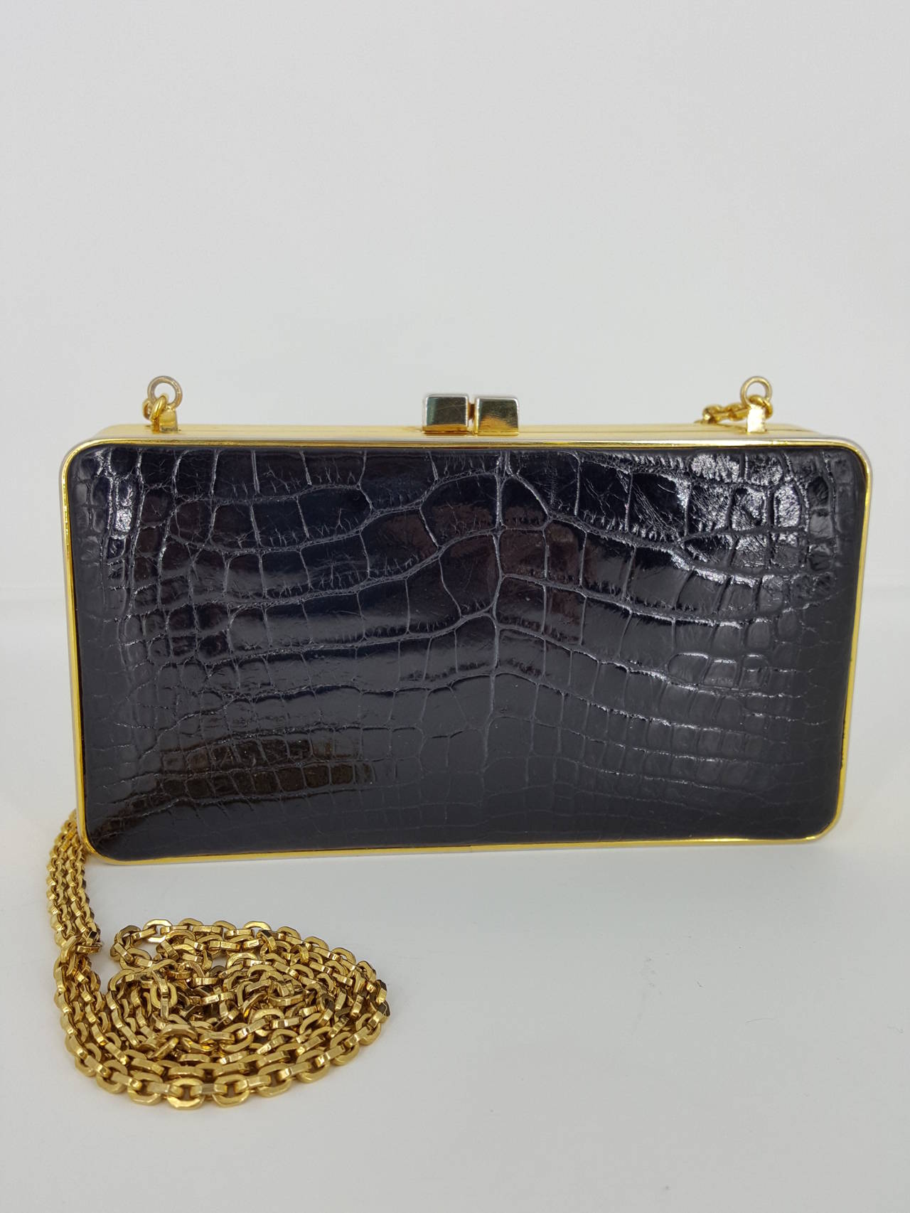 Offered for sale is this lovely Judith Leiber Baby Alligator evening bag/clutch with gold hardware and 25