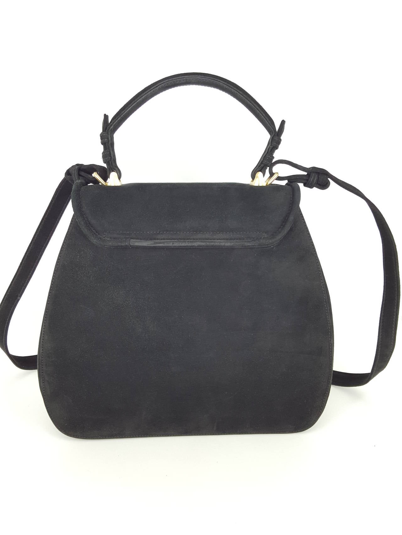 Offered for sale is the beautiful black suede Trophy bag by Barry Kieselstein Cord with the Labrador retriever closure.  The gold tone hardware on the plush black suede, gives a rich look.  From 1991, this handbag has only gently been used if at