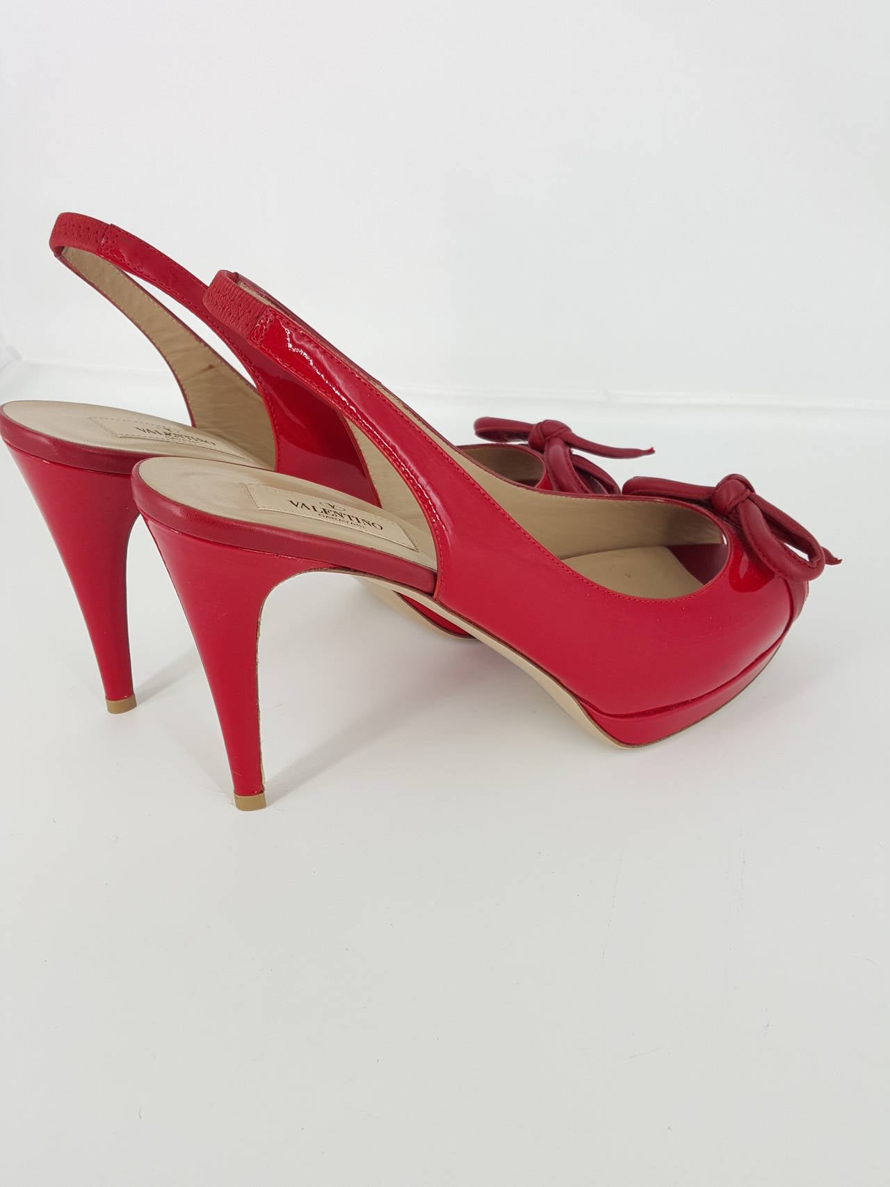 Just in time for the holidays!  What is better than Valentino Red?  These open toe  sling back high heels with a bow on the toe are perfect for the holiday. They are in size 39 1/2 and never worn. Beautiful red soft leather with a light tan leather