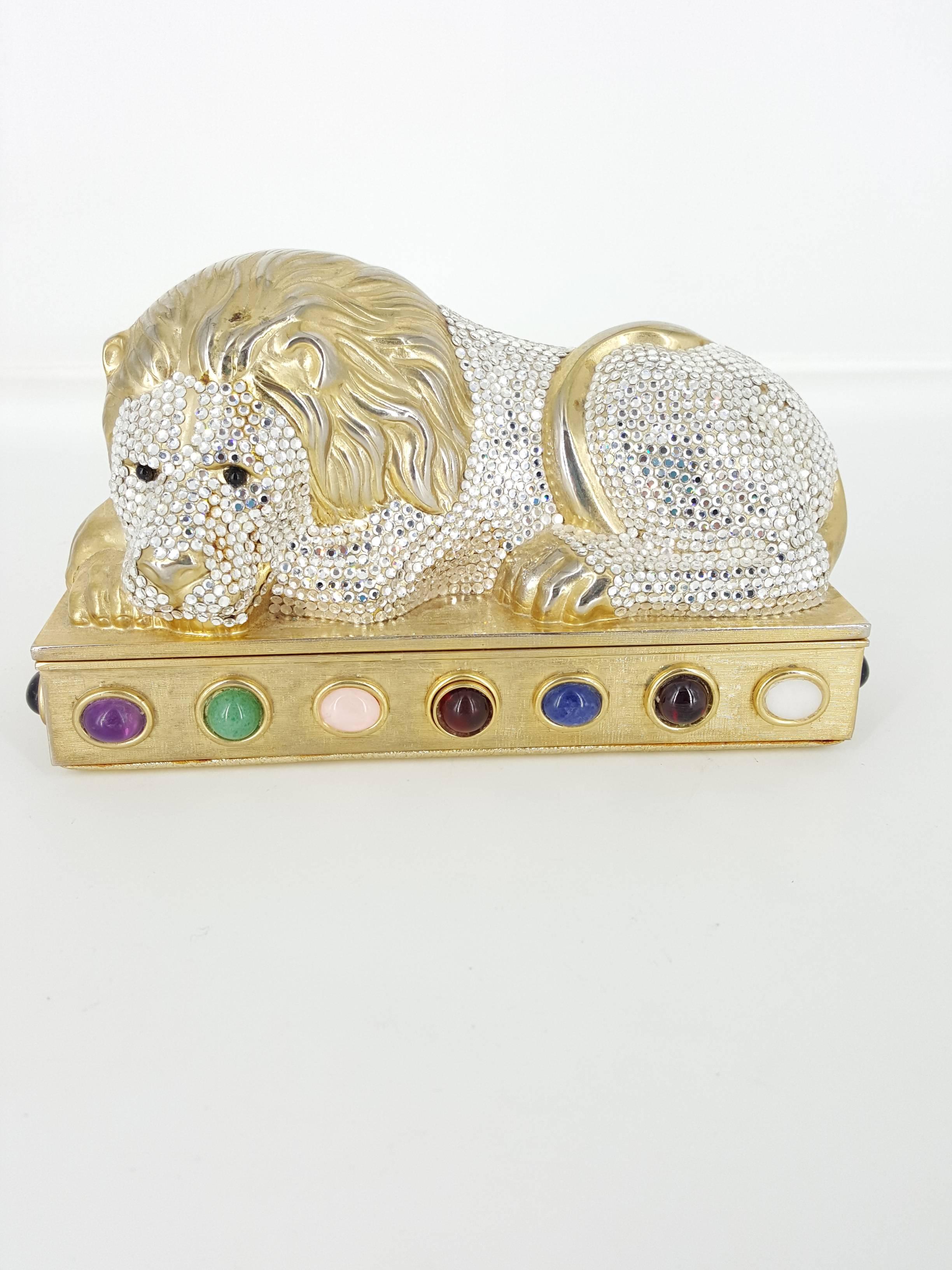 Offered for sale is this darling Lion clutch by Judith Leiber encrusted with Swavorski crystal and semi precious stones. This clutch is from 1987 and in excellent condition.  The lion has black onyx eyes and there are 20 cabochon semi precious