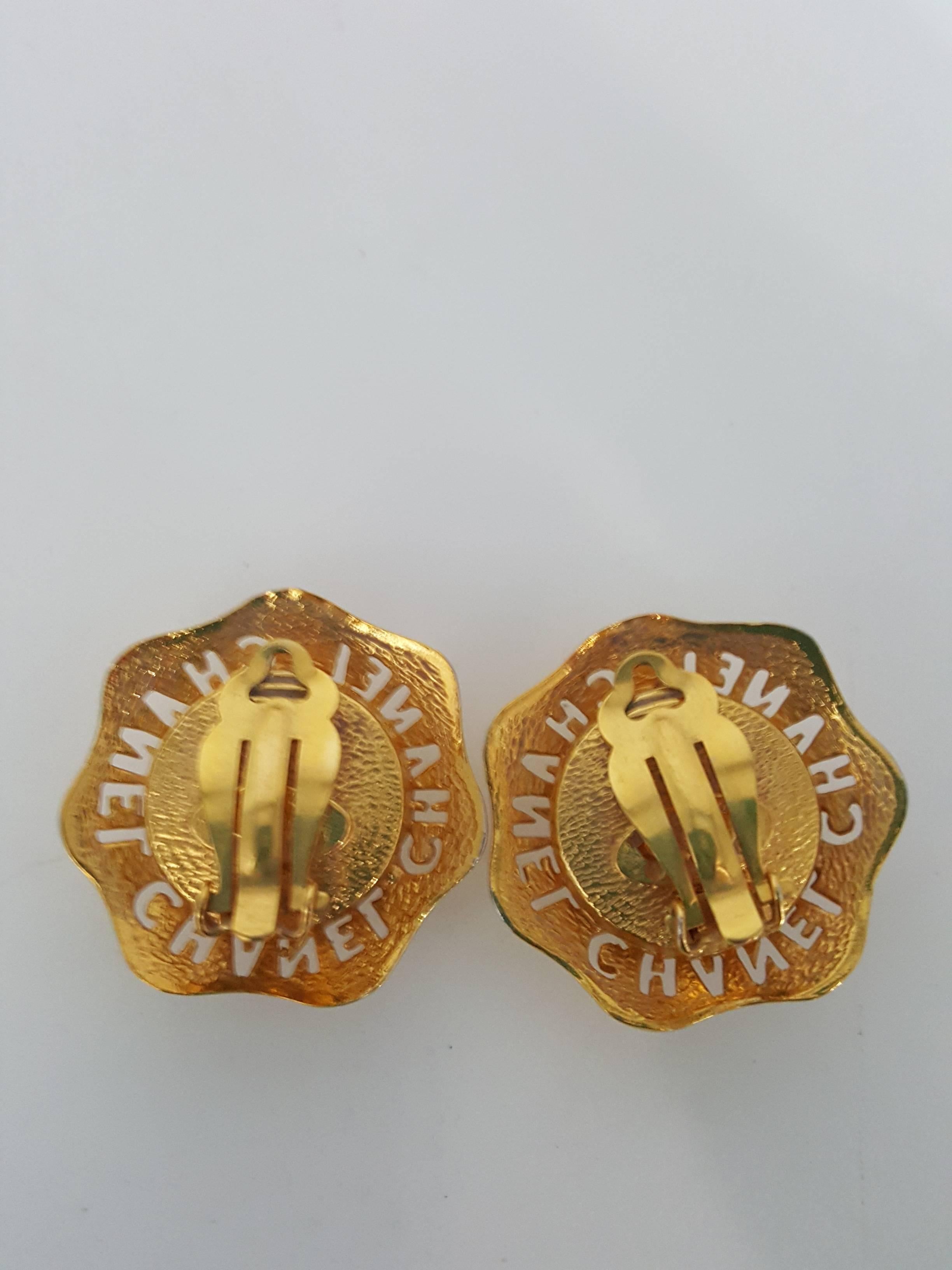 Offered for sale are these rare and Vintage Chanel clip on earrings with Chanel cut out around a large pearl.  These are in bright gold and in excellent condition for the 80's.  They measure 1 1/2
