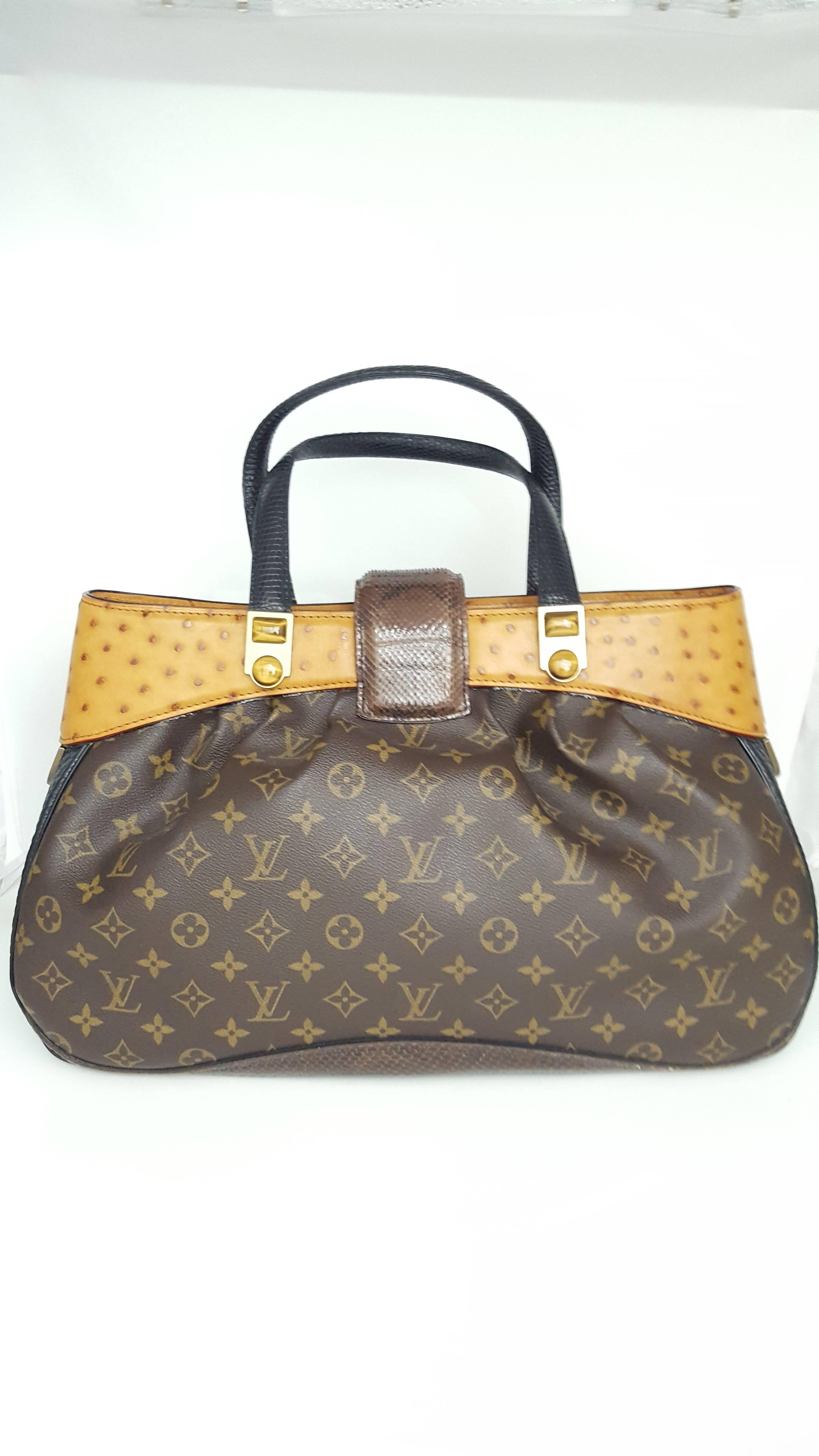 Offered for sale is this fabulous Louis Vuitton designed by Marc Jacobs for the 2005-2006 show.  It is the Oskar Waltz.  This bag was never carried and is in new condition.  With its supple pleats and the use of three exotic skins, Ostrich, Lizard,
