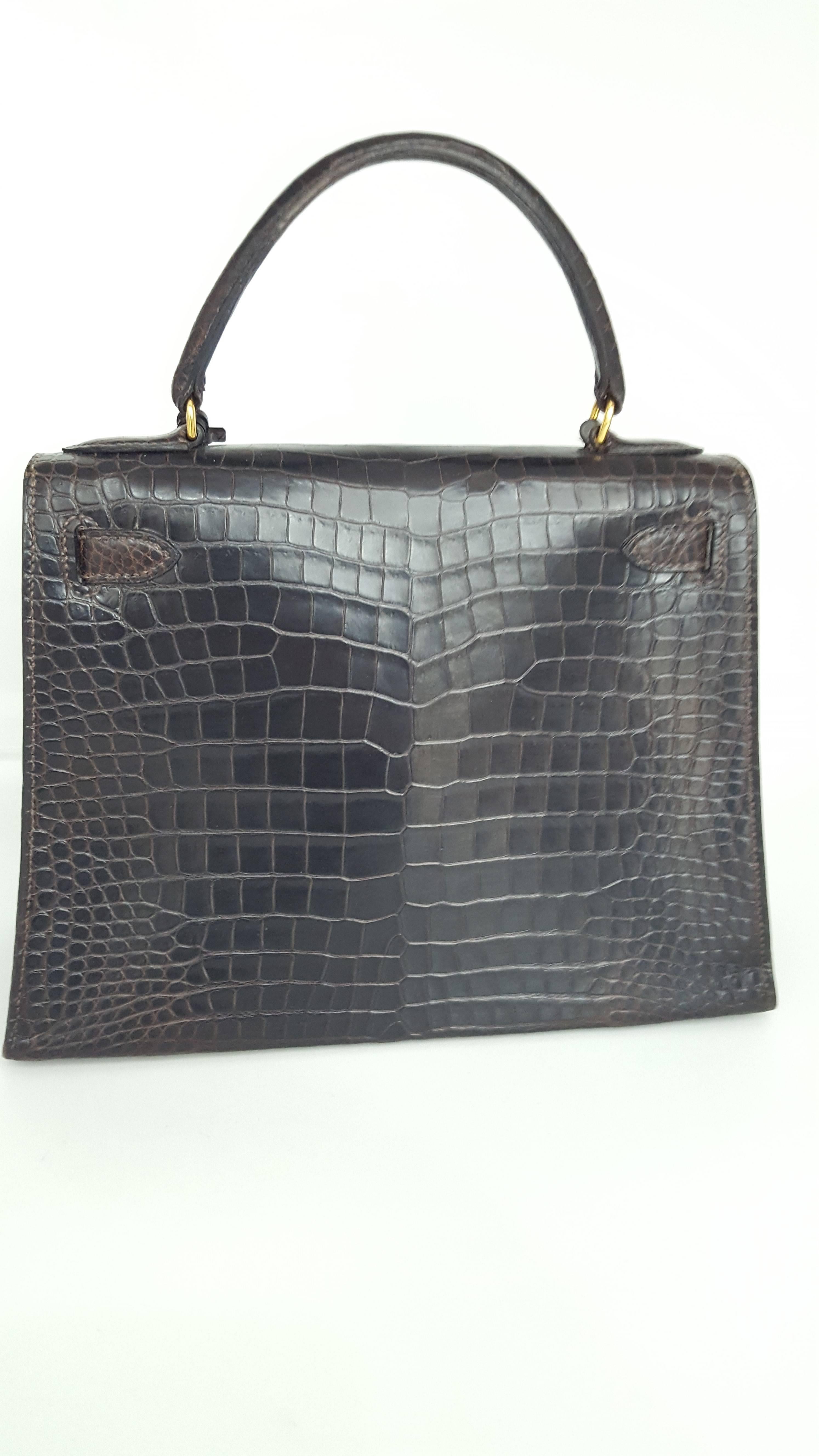 Offered here is a vintage Hermes Kelly 28 cm in a rich dark brown shiny crocodile from 1985.  This bag is in mint condition. The color is so dark it appears black.  All hardware in excellent condition. 
will ship with original lock, keys, and dust