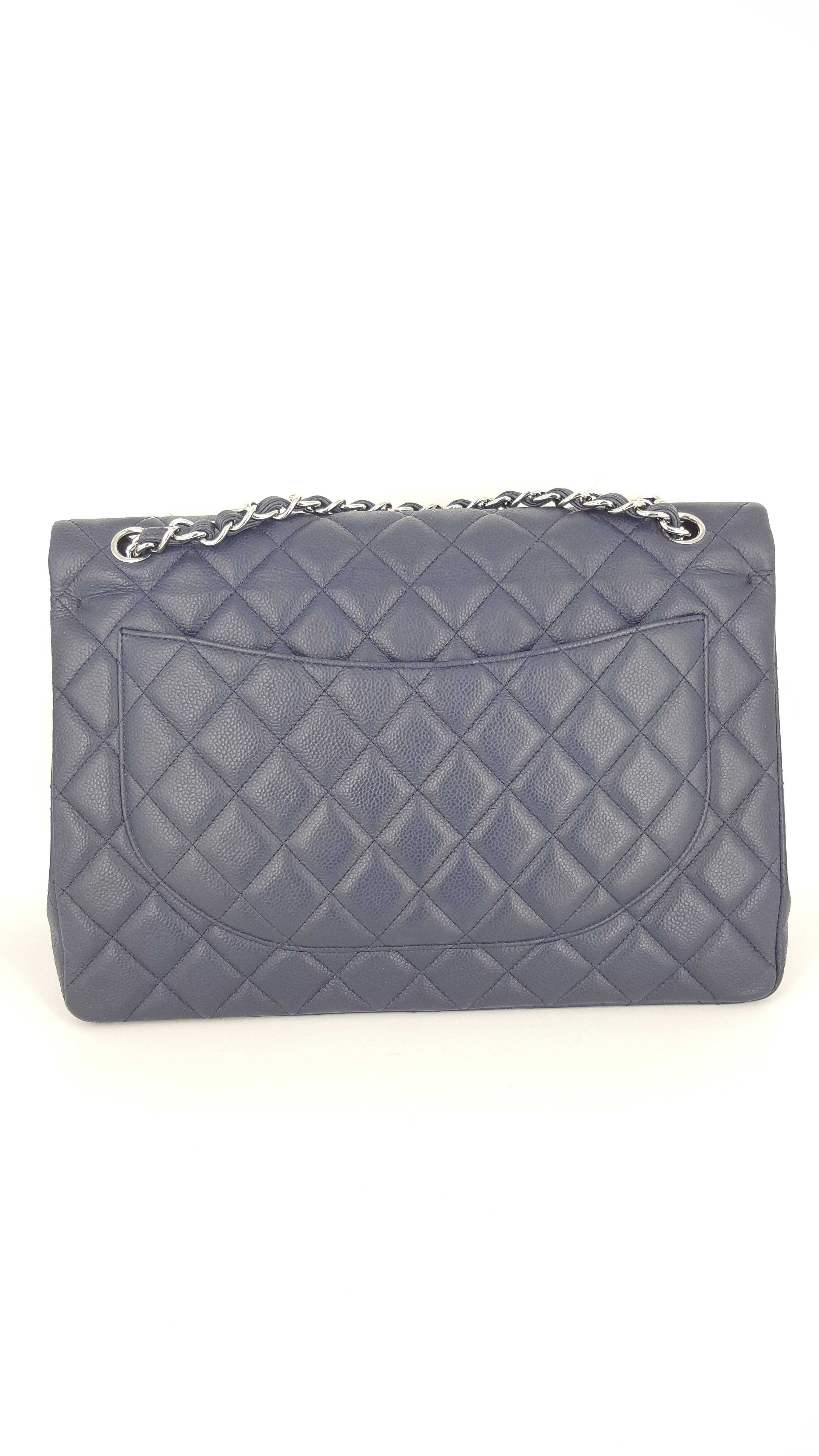 Offered for sale is this beautiful navy blue Chanel Maxi double flap in caviar with silver hardware.  This bag was manufactured in Italy in 2011 and is in excellent condition.  It measures 13