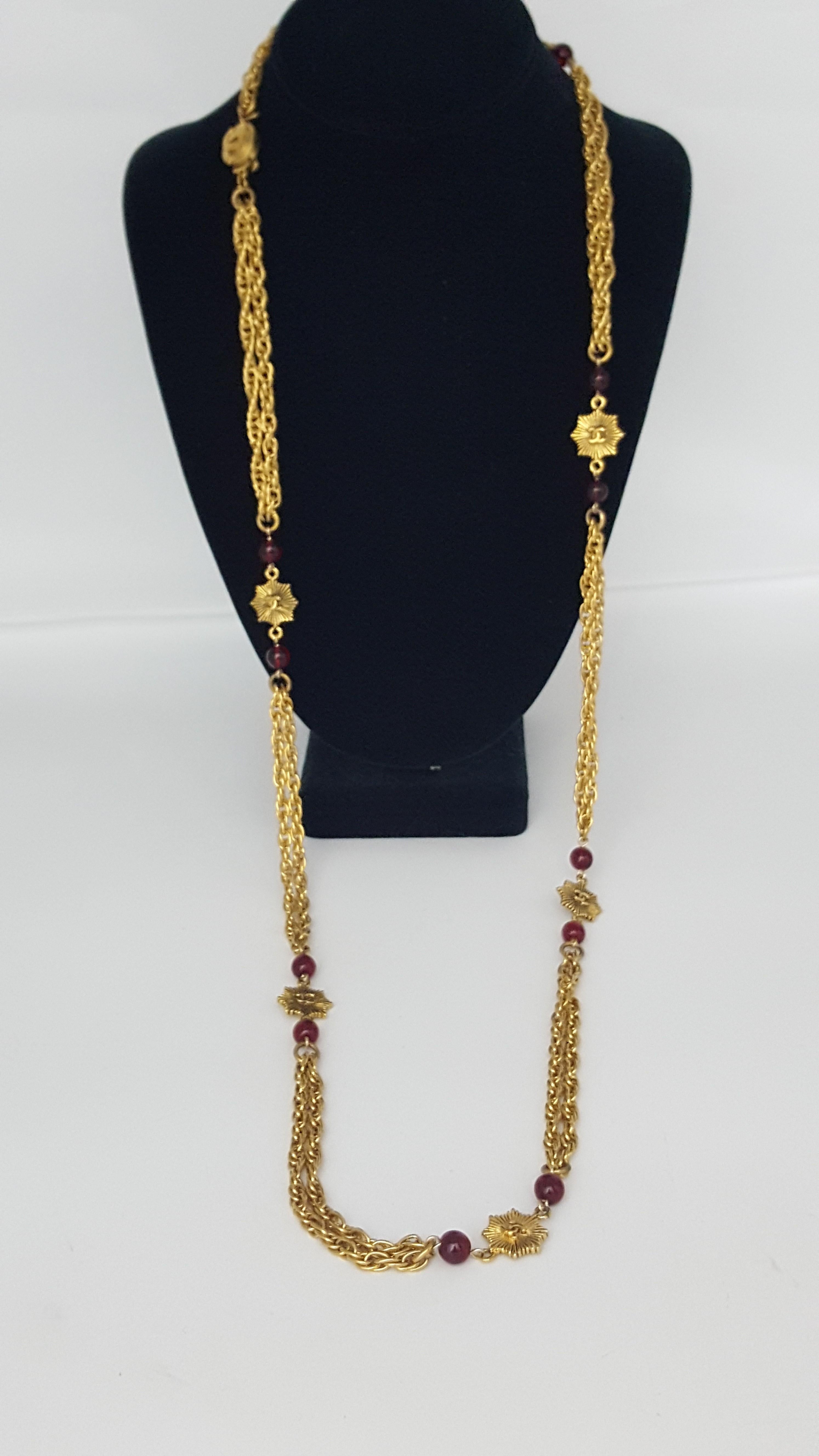 Offered for sale is this beautiful vintage Chanel necklace from 1984.  There are 12 ruby gripoix beads with 7 gold tone double sided  CC medallions in between.  The beautiful chain is doubled between each. There is a CC clasp are rear of necklace. 