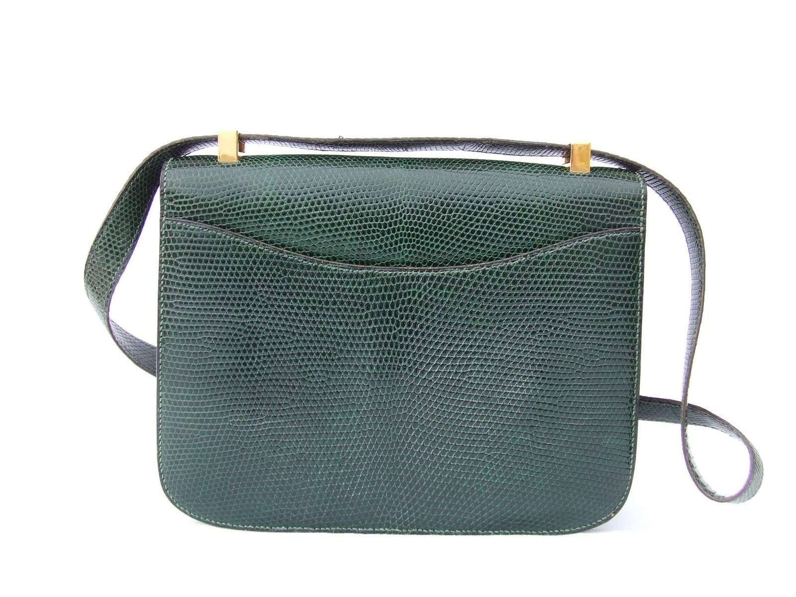 GORGEOUS AUTHENTIC VINTAGE HERMES FLAP BAG

CONSTANCE

Made in France

Stamp E in a circle

Made of Lizard Skin and Golden Hardware

Colorway: Emeral Green

Lined with dark green smooth leather

1 main pocket, 1 zippered pocket (zip